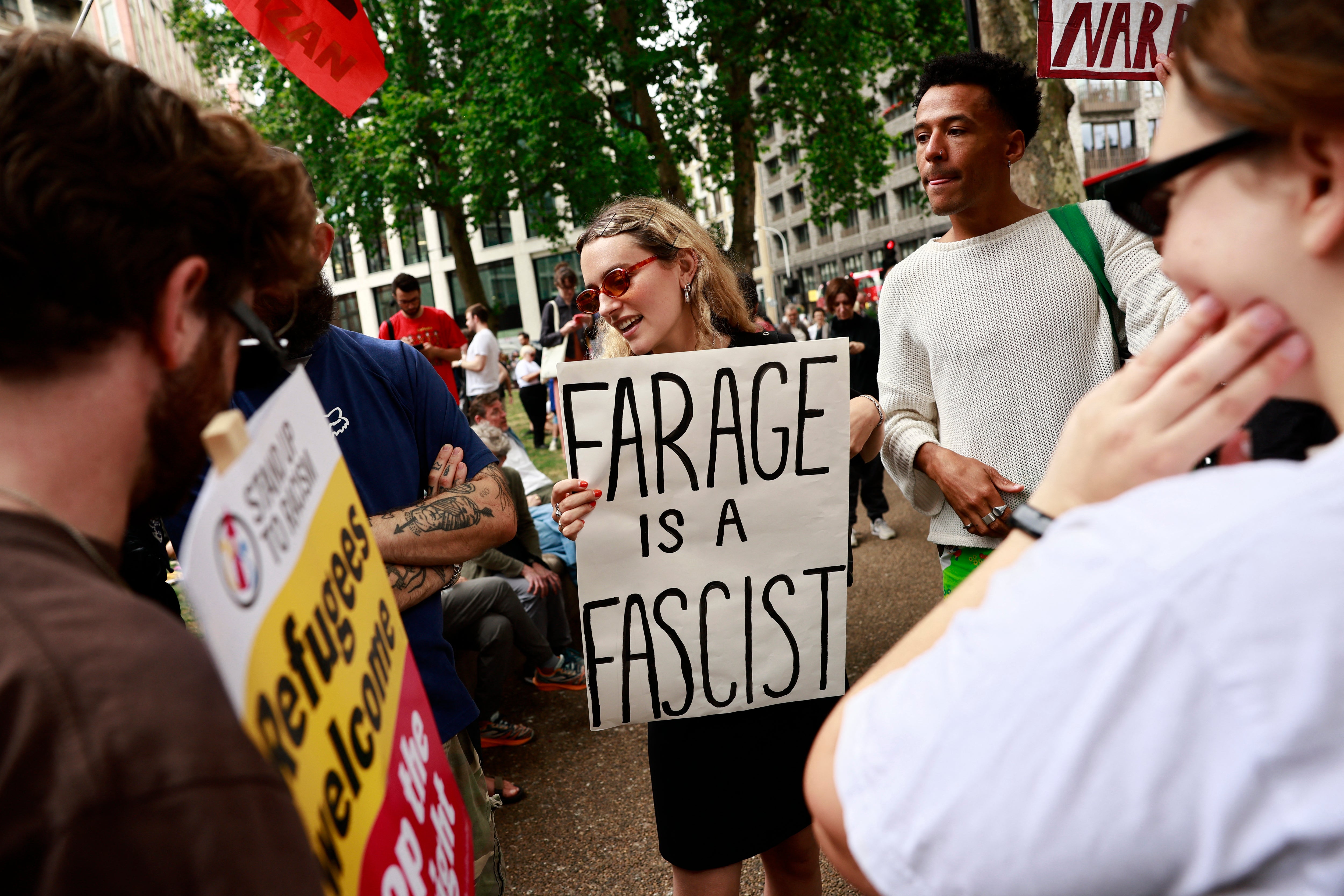 People take part in a “Stop the Far Right” demonstration outside the headquarters of the British Reform Party.