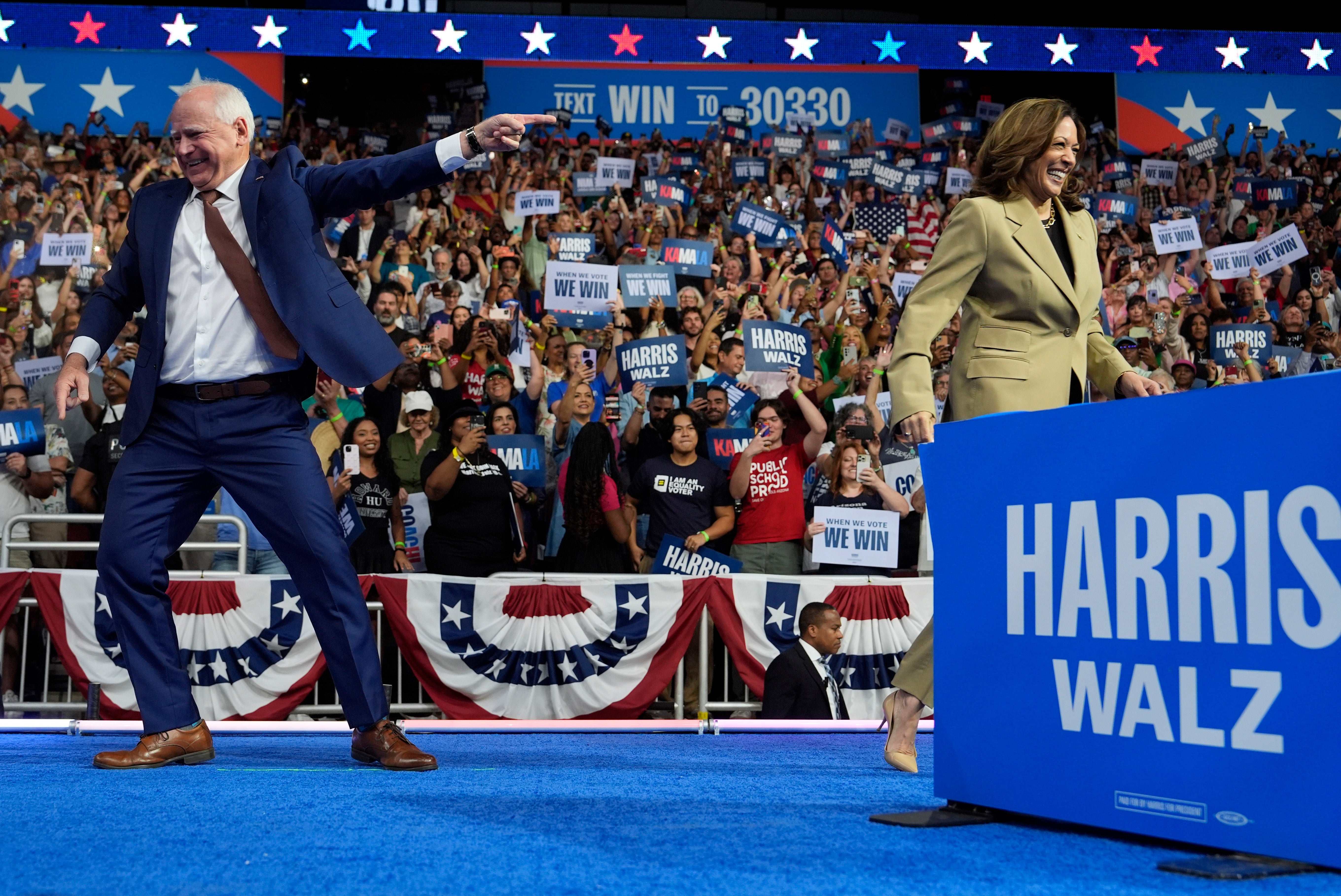 Democratic presidential candidate Kamala Harris and her running mate, Minnesota Governor Tim Walz, at a campaign rally in Arizona.