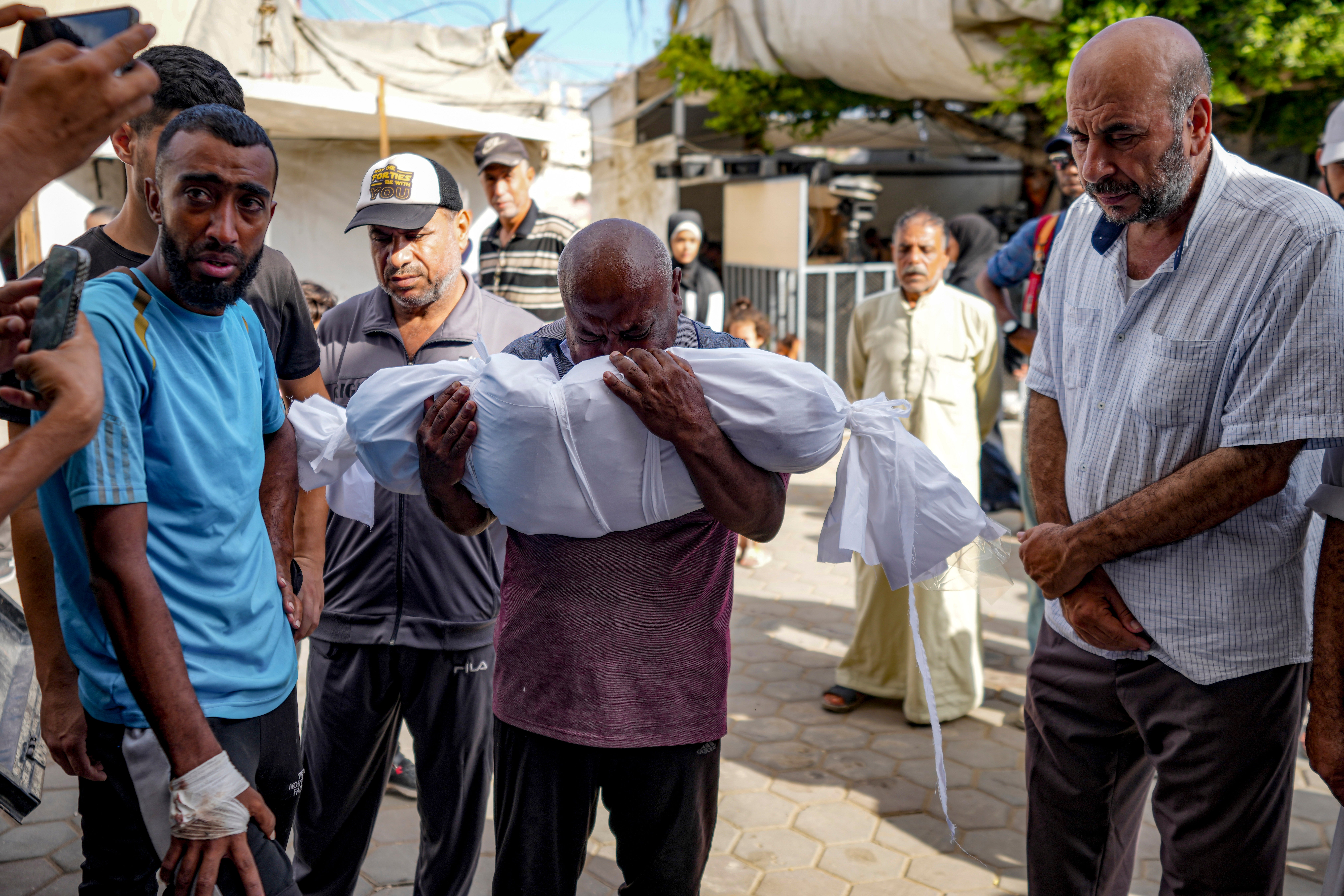 Palestinians mourn for a relative killed in the Israeli bombardment of the Gaza Strip, at a hospital in Deir al-Balah