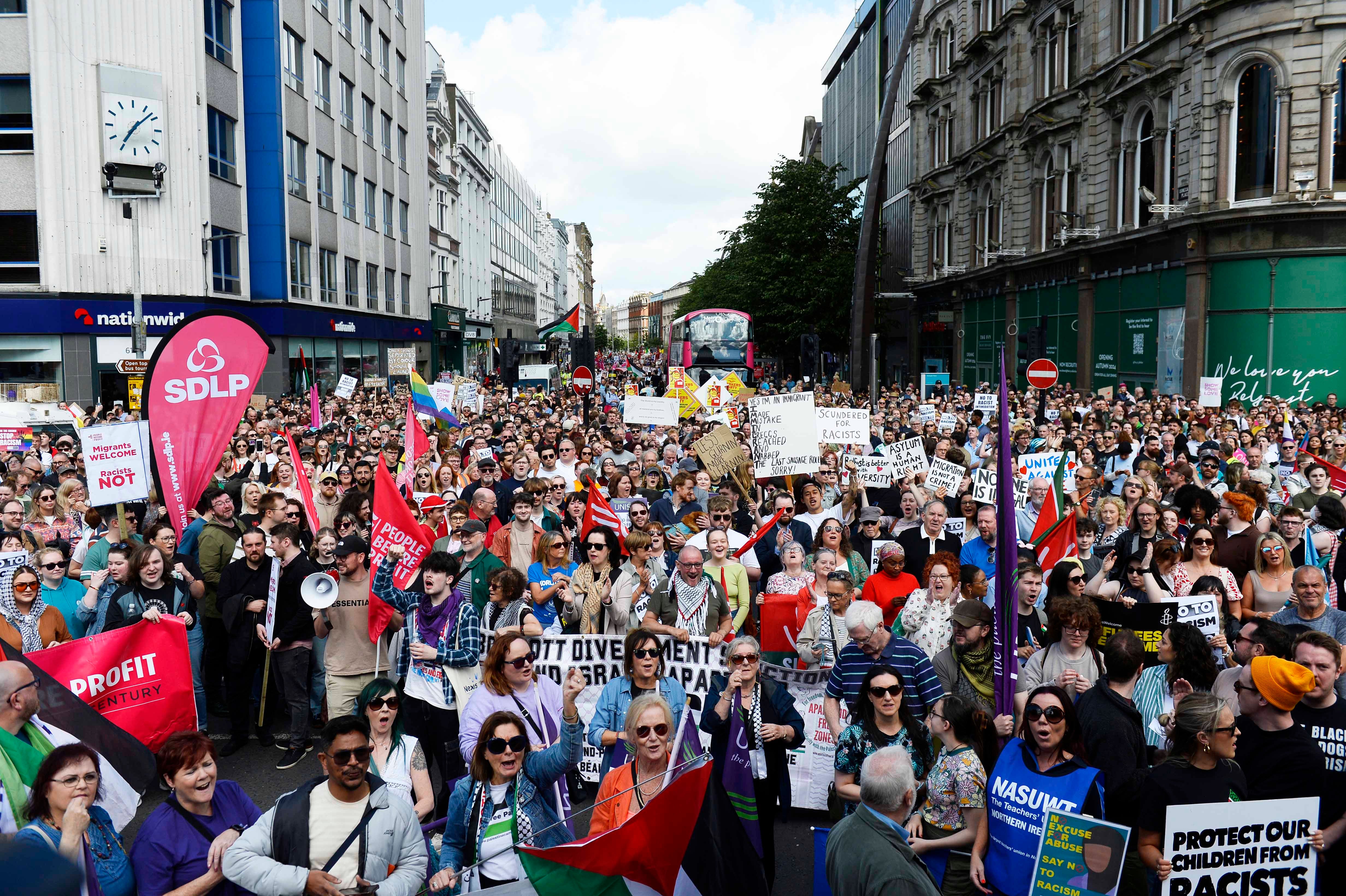 Demonstrators take part in a United Against Racism rally in Belfast on Saturday