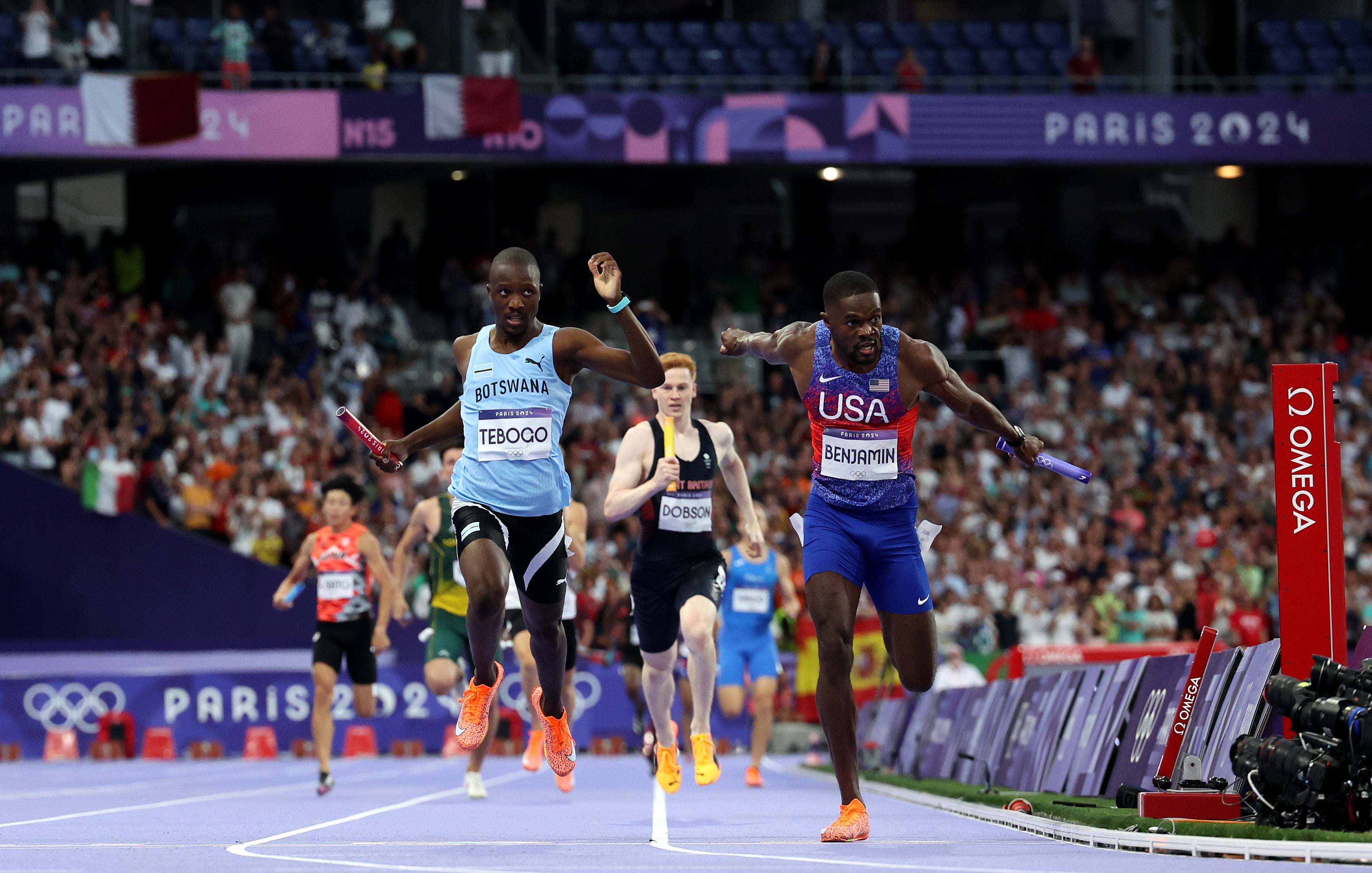 Rai Benjamin of Team USA celebrates winning the Gold medal in front of silver medalist Letsile Tebogo of Team Botswana