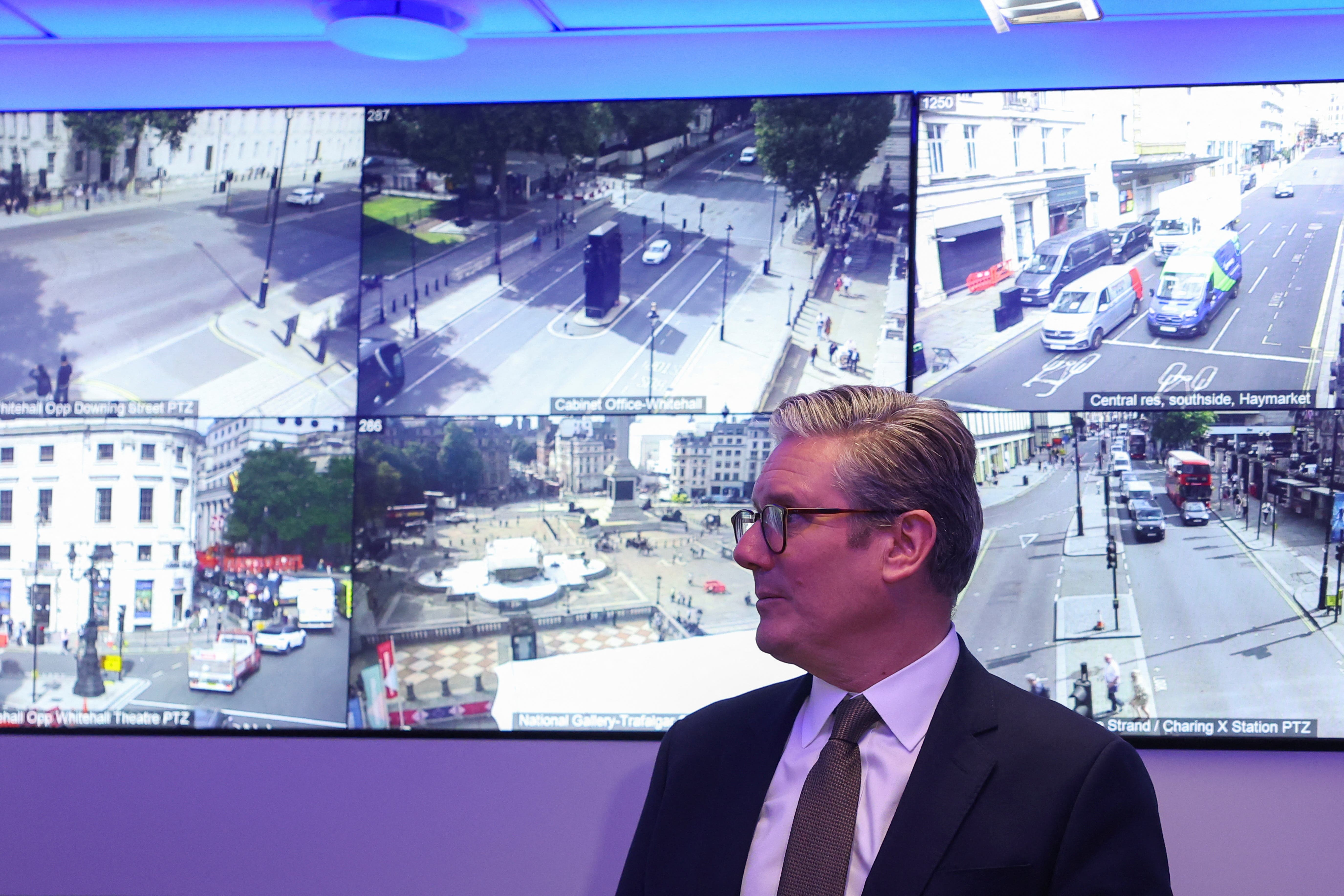 Prime Minister Sir Keir Starmer stands beside CCTV screens (Toby Melville/PA)