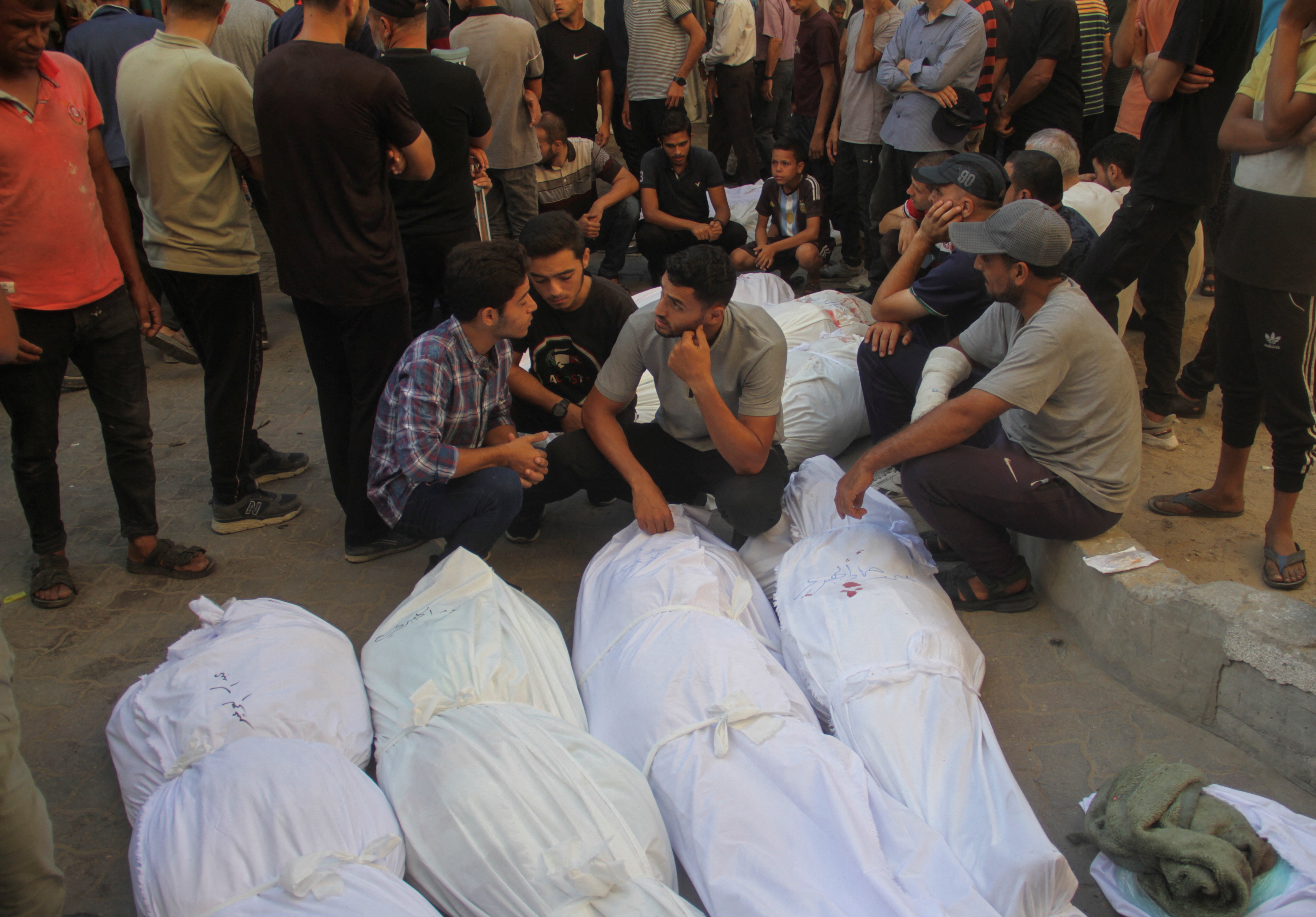 Families with victims of the strike on the school in Gaza City