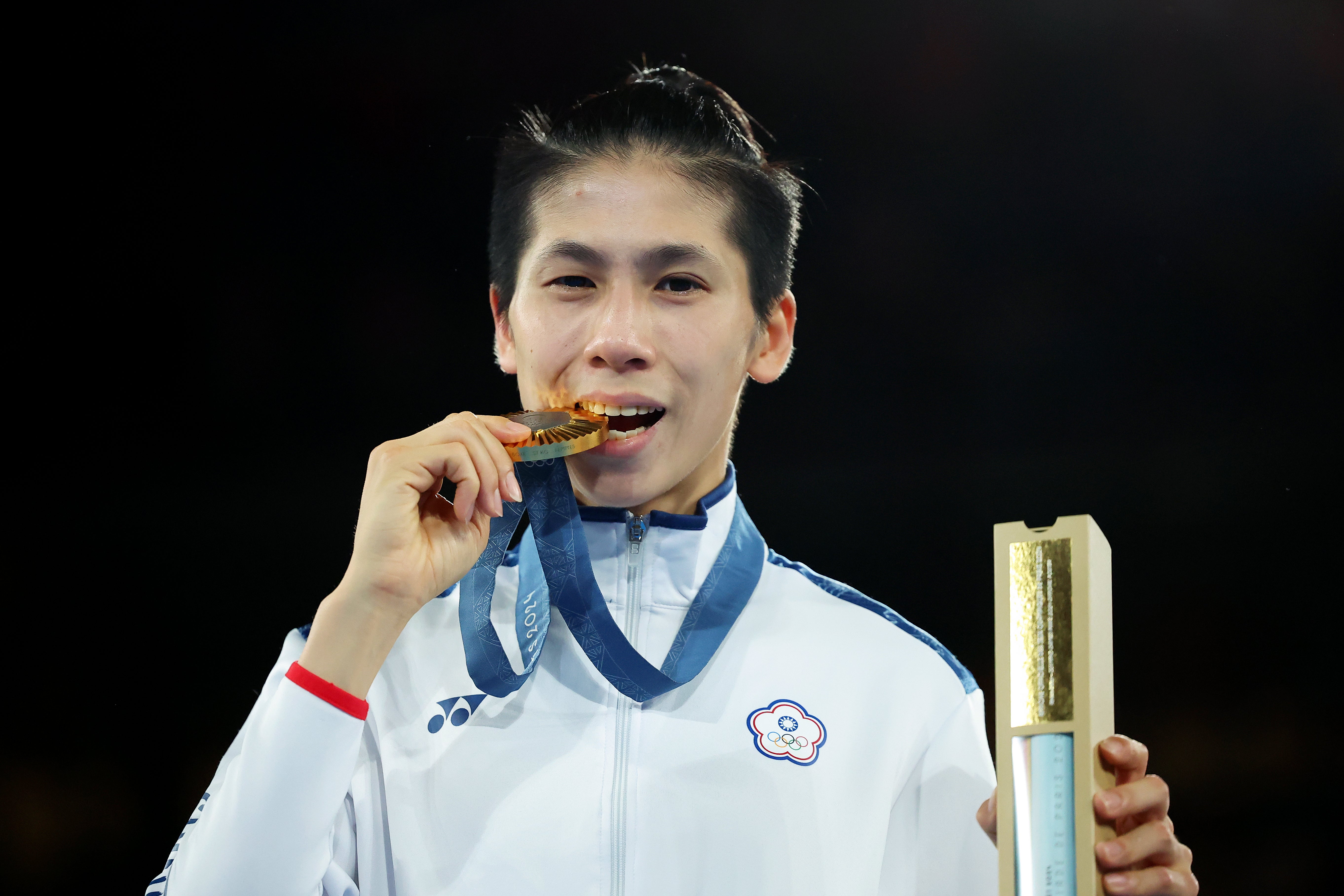 Gold Medallist Yu Ting Lin of Team Chinese Taipei bites her medal