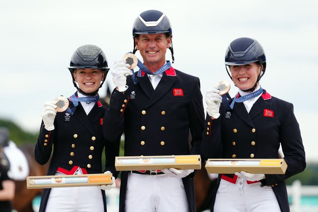 Charlotte Fry, Carl Hester and Becky Moody put a troubled preparation behind them to win team dressage bronze (Mike Egerton/PA)