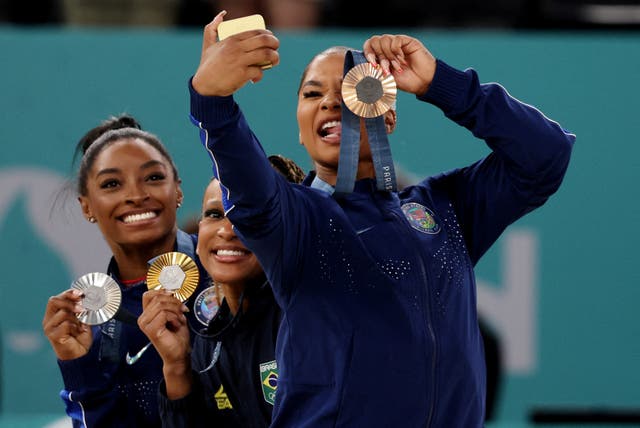 <p>Bronze medallist Jordan Chiles snaps a photo alongside gold medallist Rebeca Andrade and silver medallist Simone Biles. Chiles was forced to return her bronze medal after an independent governing body’s decision </p>