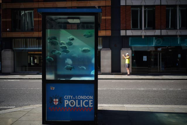 A new swimming fish artwork which has appeared on a police sentry box in the City of London has been confirmed to be by Banksy (Yui Mok/PA)