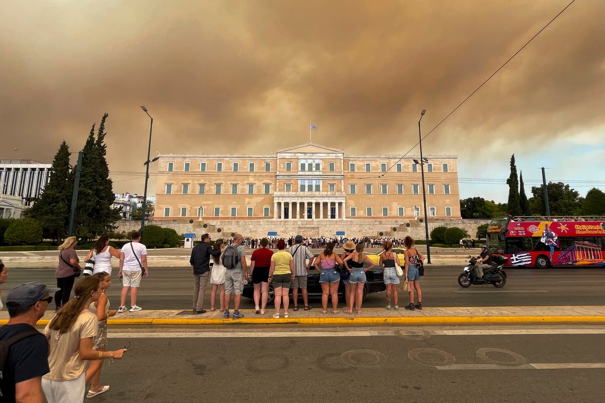 Greece wildfires force thousands to flee historic site and popular tourist towns