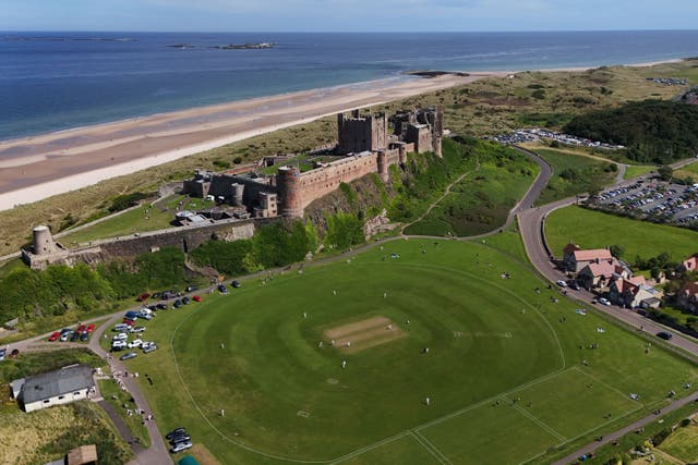 Bamburgh Castle Cricket Club play Davipart Cricket Club in the warm weather at Bamburgh Castle Cricket Club (Owen Humphreys/PA)