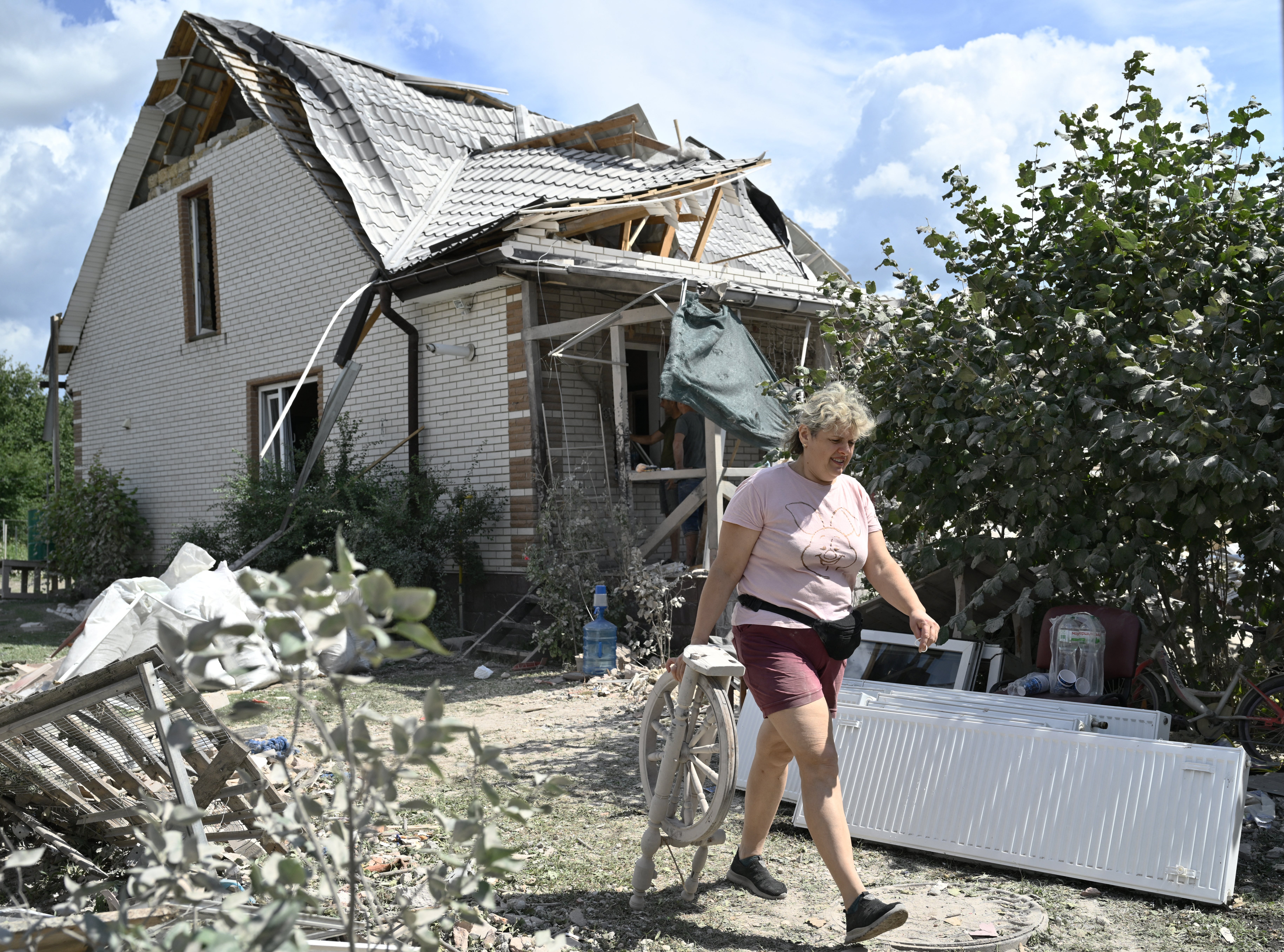 A local resident saves belonging from a residential house