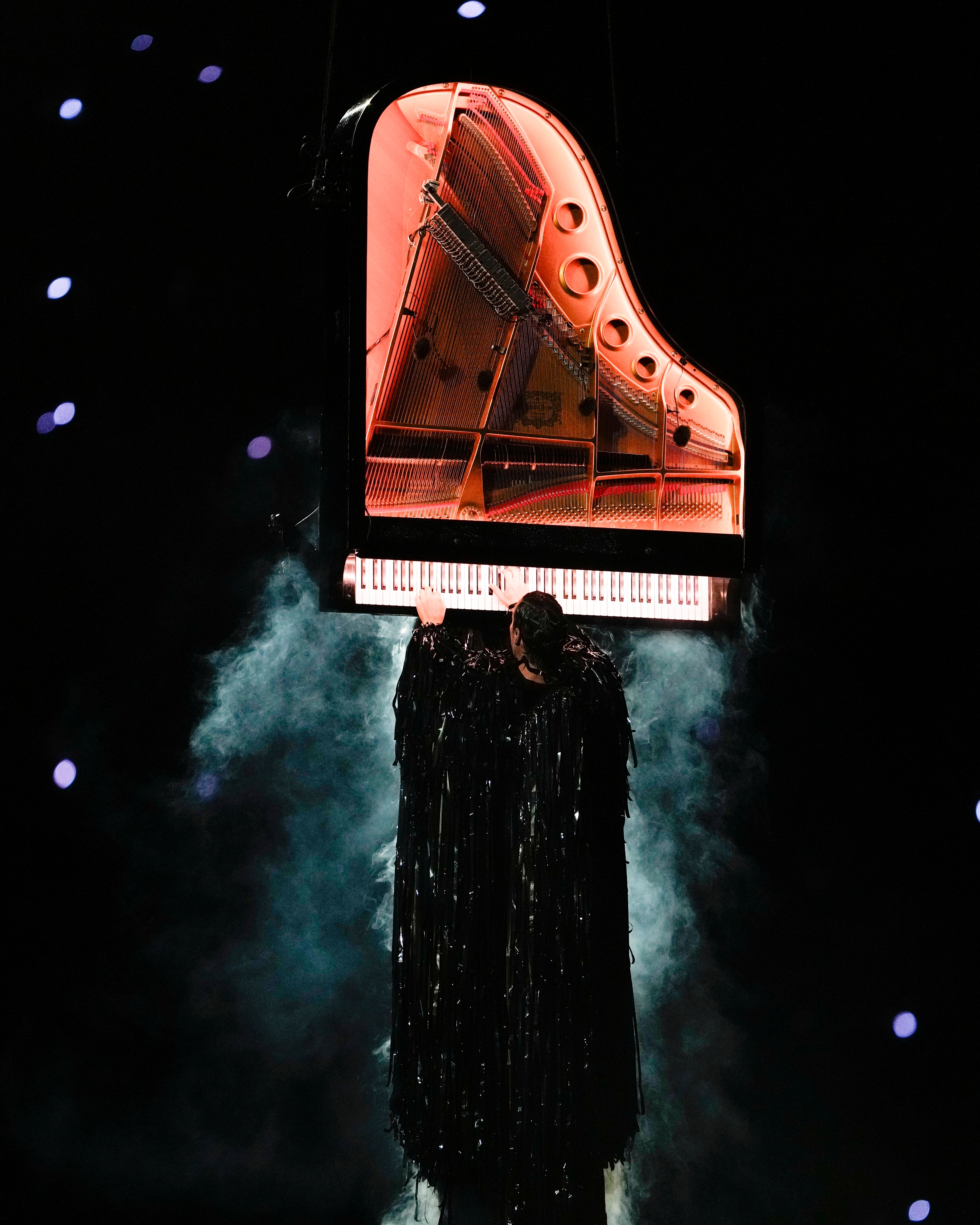 Artist Alain Roche plays a piano during the 2024 Summer Olympics closing ceremony at the Stade de France