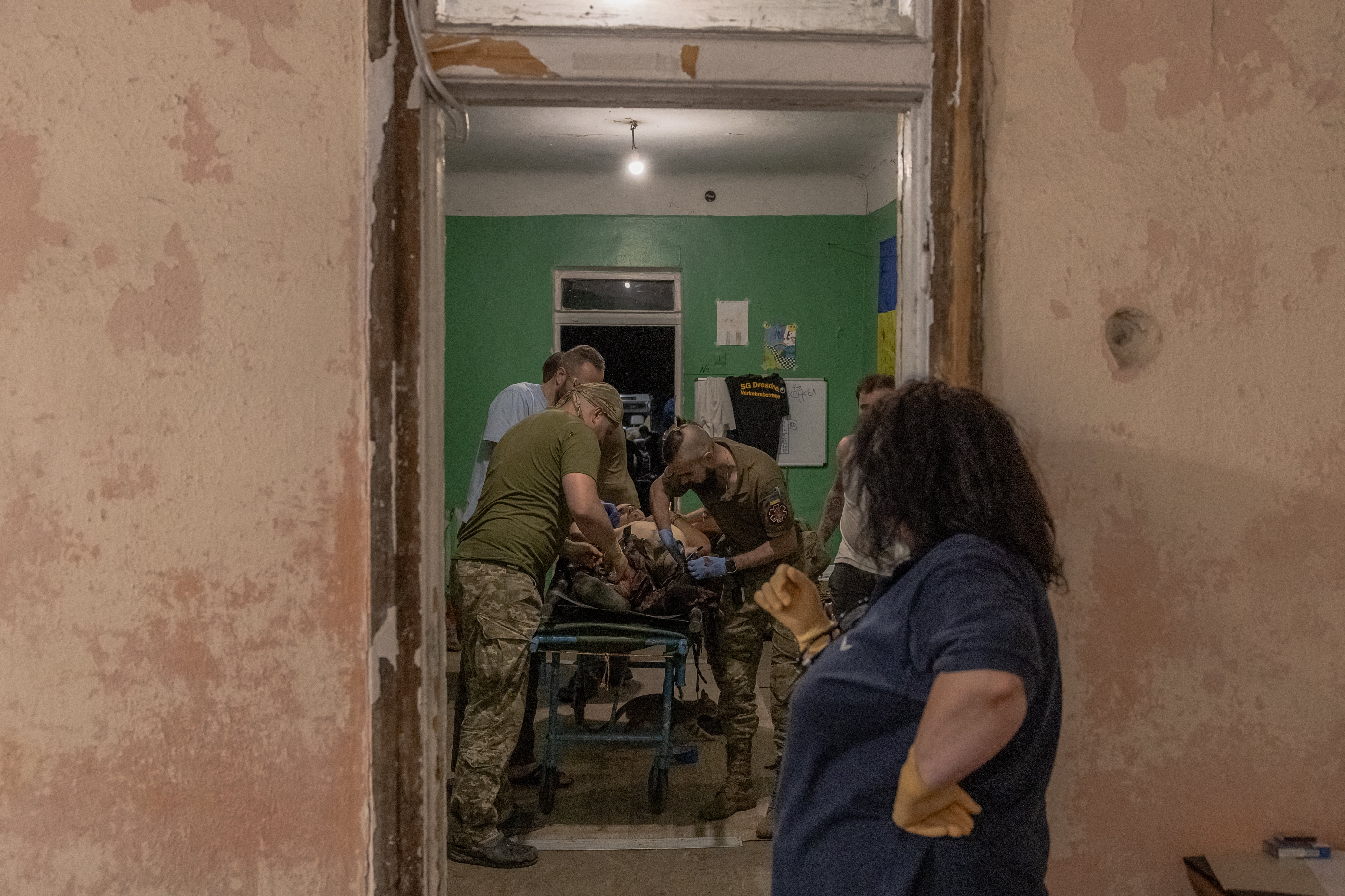 A Ukrainian wounded serviceman who was brought back from positions is treated by Ukrainian military medics at a stabilization point of the 47th Mechanized Brigade "Magura", in Pokrovsk district, in the eastern Donetsk region