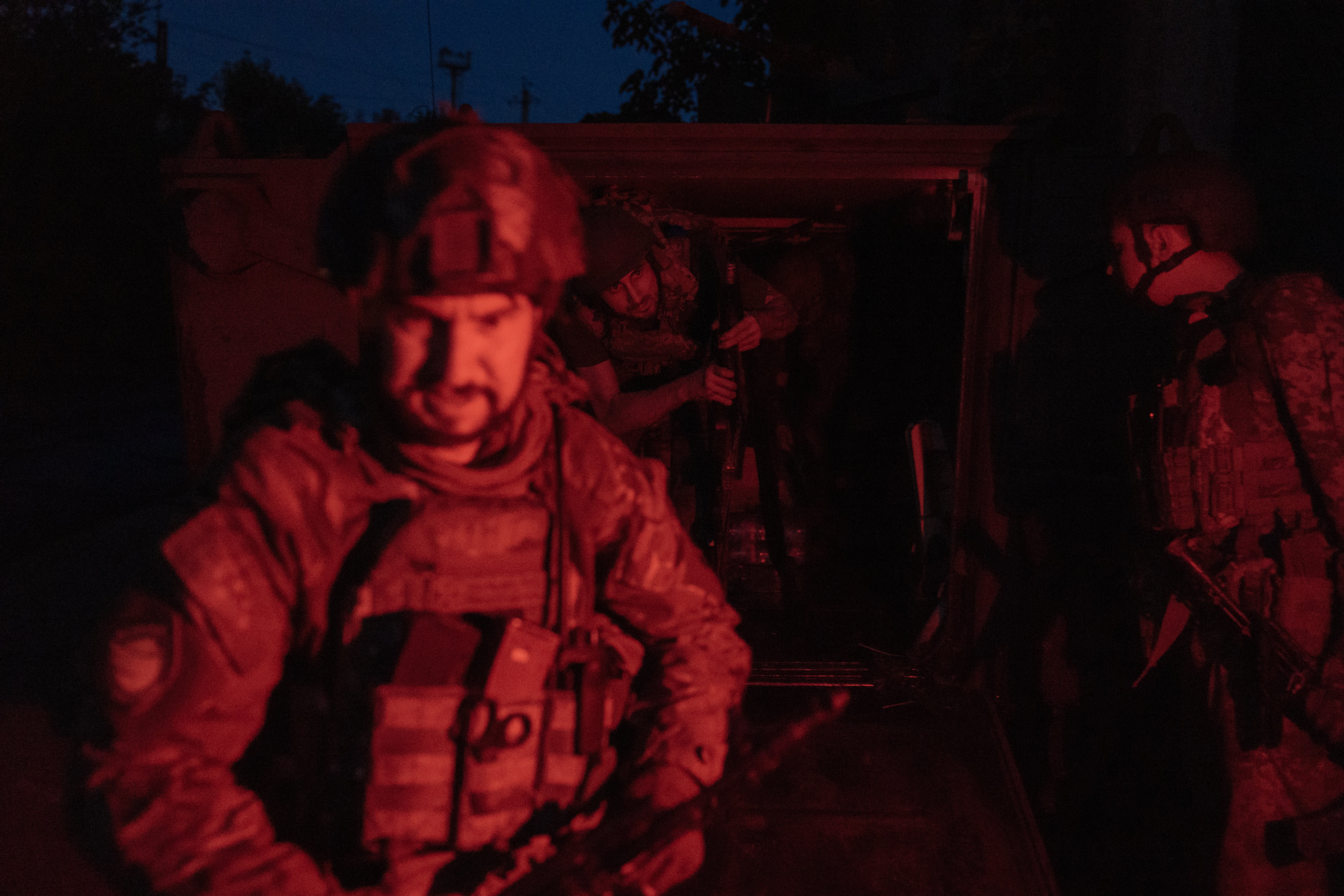 Ukrainian soldiers who arrived from the front disembark from a US-made M113 armoured personnel carrier in an undisclosed area in the eastern Donetsk region