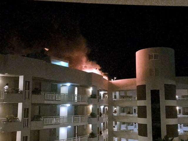 <p>A fire burns at the Double Tree Hotel after a helicopter crashed into the roof in Cairns</p>