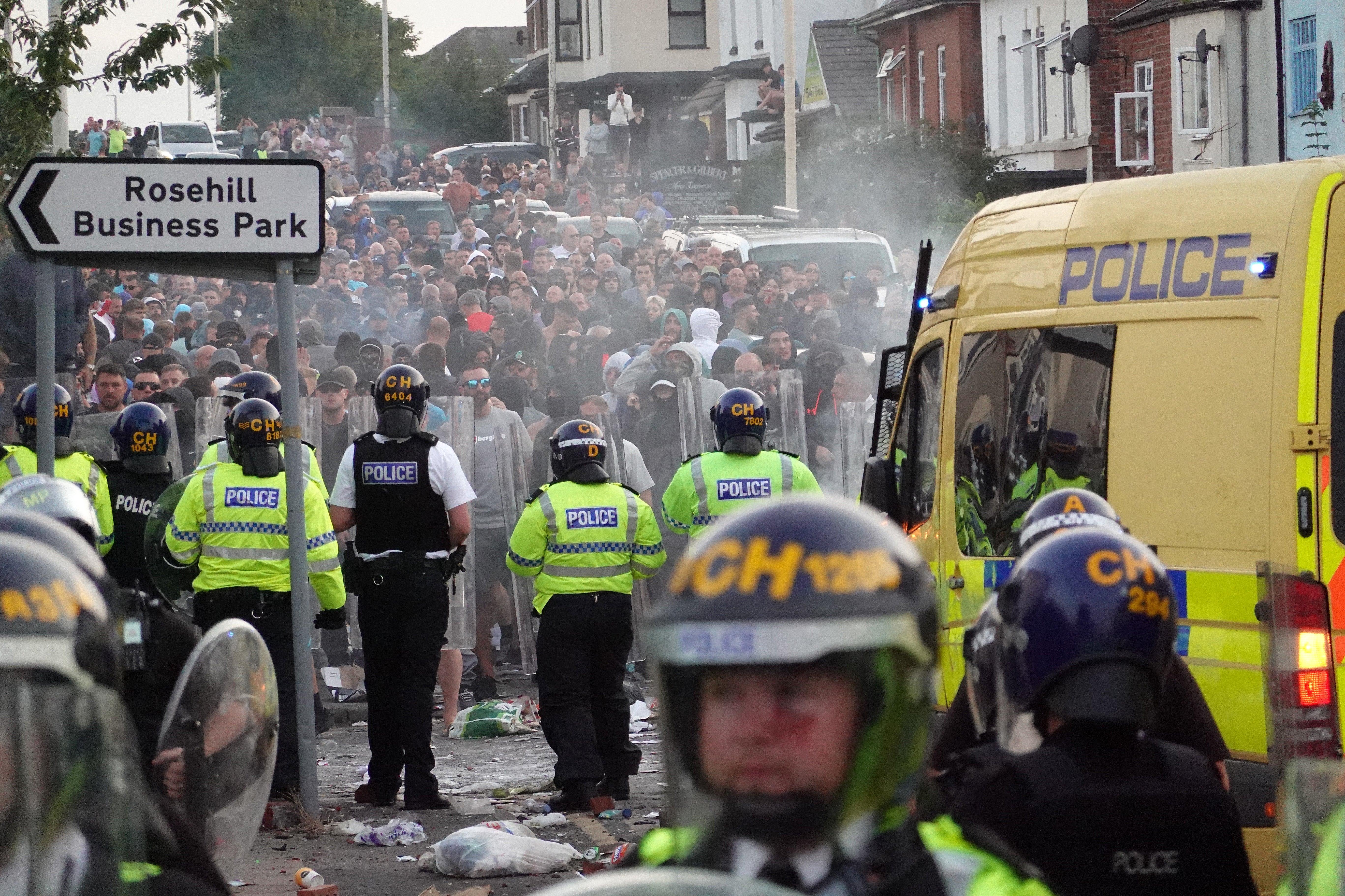 Riot police hold back far-right demonstrators after disorder broke out on 30 July in Southport