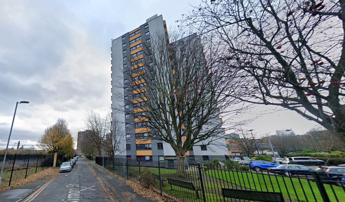 Two people have been arrested after a man fell from a balcony in Black Friar Court in Salford