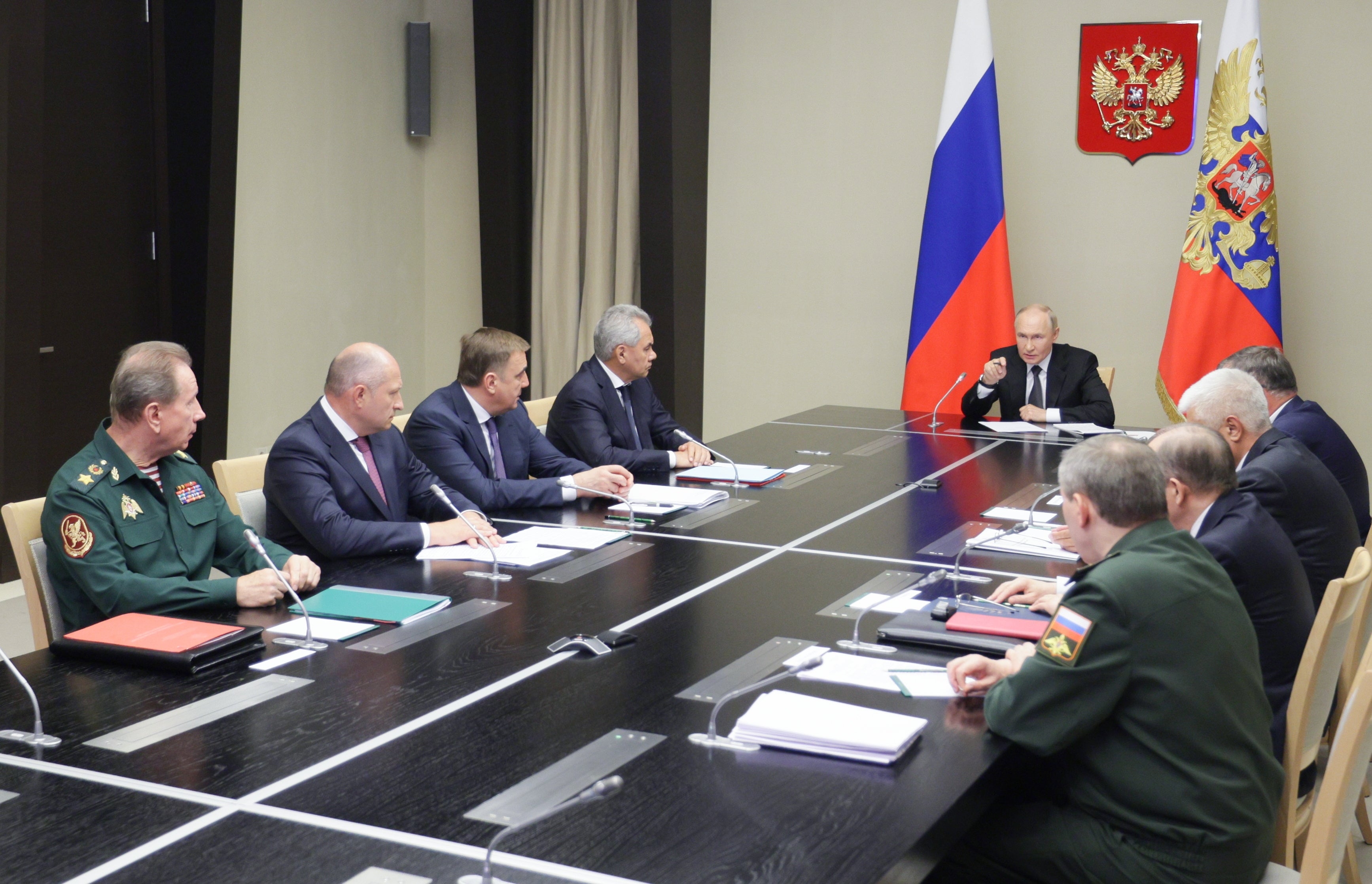 Russian President Vladimir Putin (C) holds a meeting with members of the Security Council, the government, representatives of the Presidential Administration and governors of Belgorod, Kursk and Bryansk regions following a cross-border attack by Ukraine