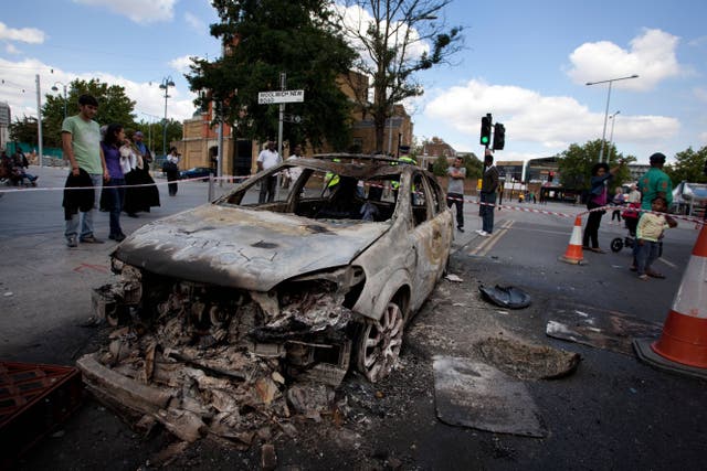 A burnt-out police car in Woolwich after the 2011 riots (Alamy/PA)