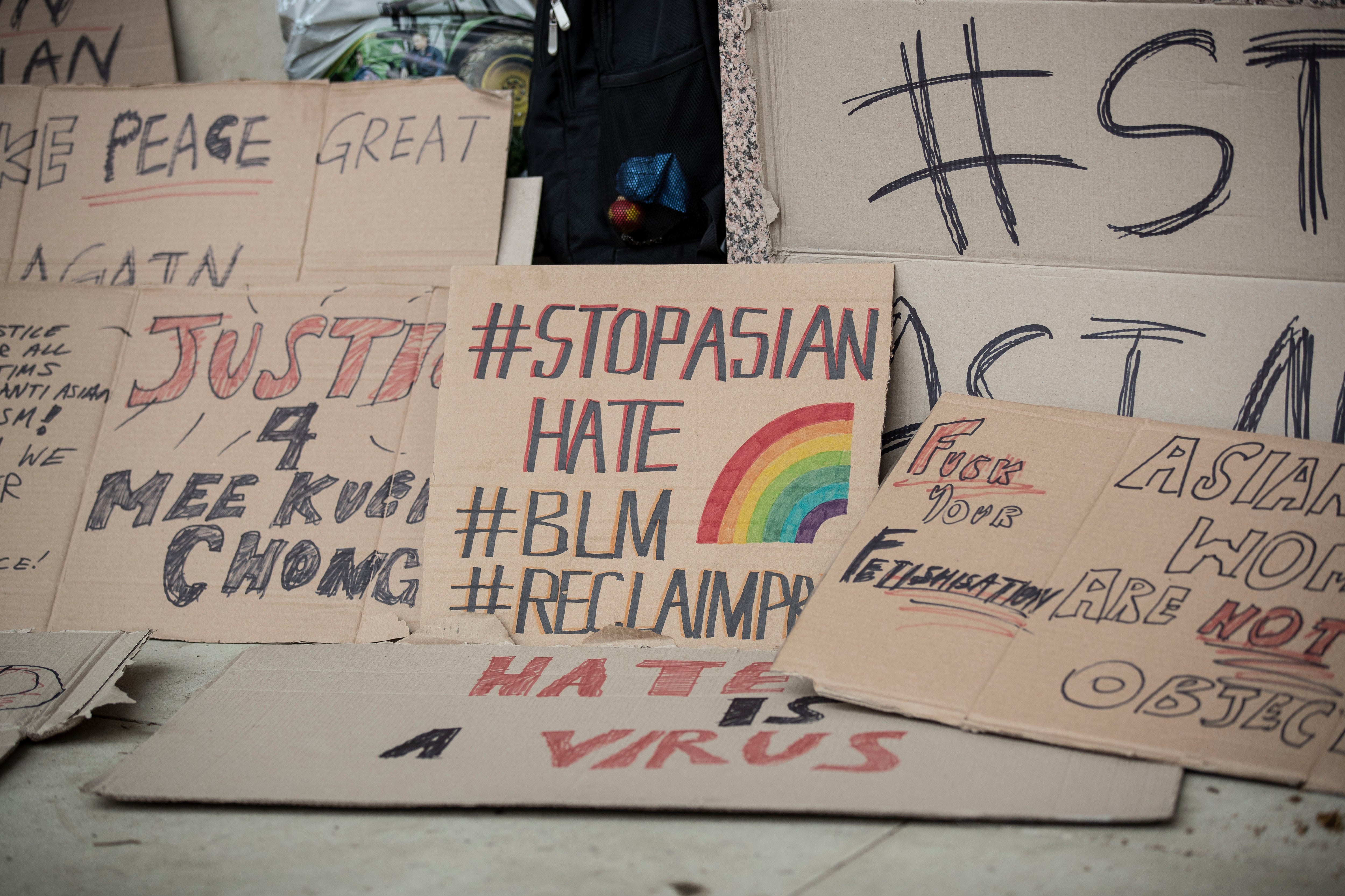 Placards are seen outside Parliament Square during the Stop Asian Hate rally in London in 2021