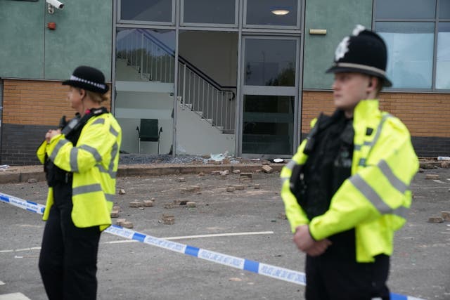 <p>Police outside the Holiday Inn hotel in Tamworth the day after the disorder</p>