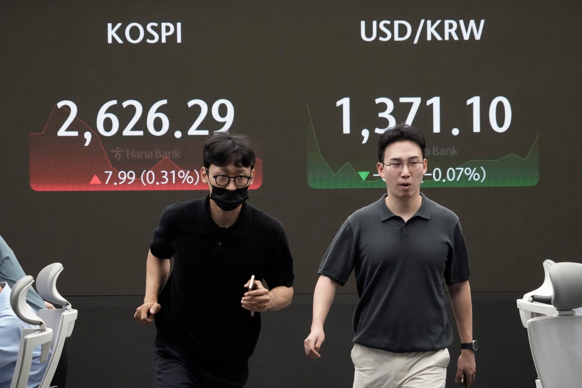 Asian shares trade mixed as Japan and other markets calm from a previous week of crazy swings