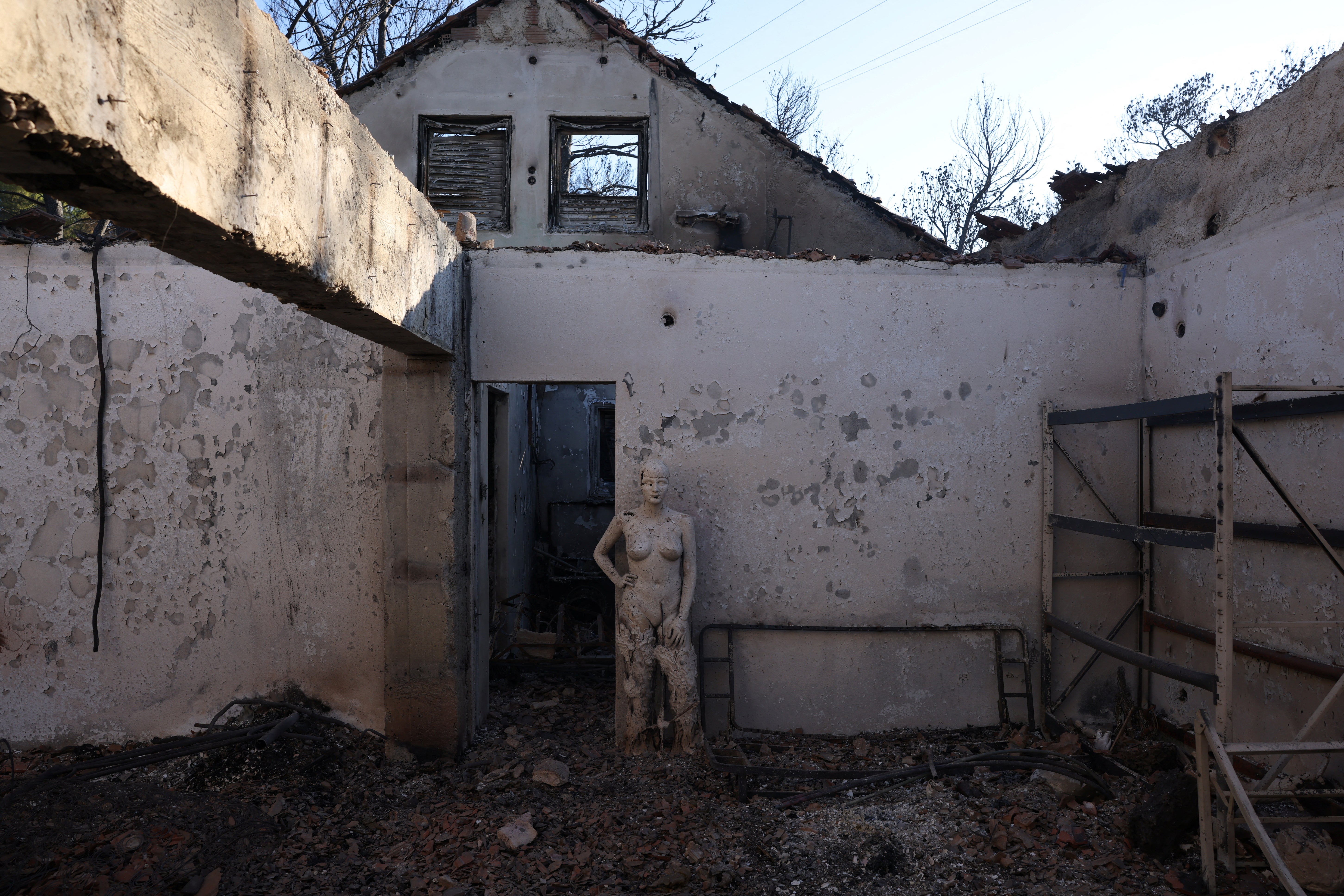 Burned houses are seen following a wildfire in the Penteli area near Athens, Greece