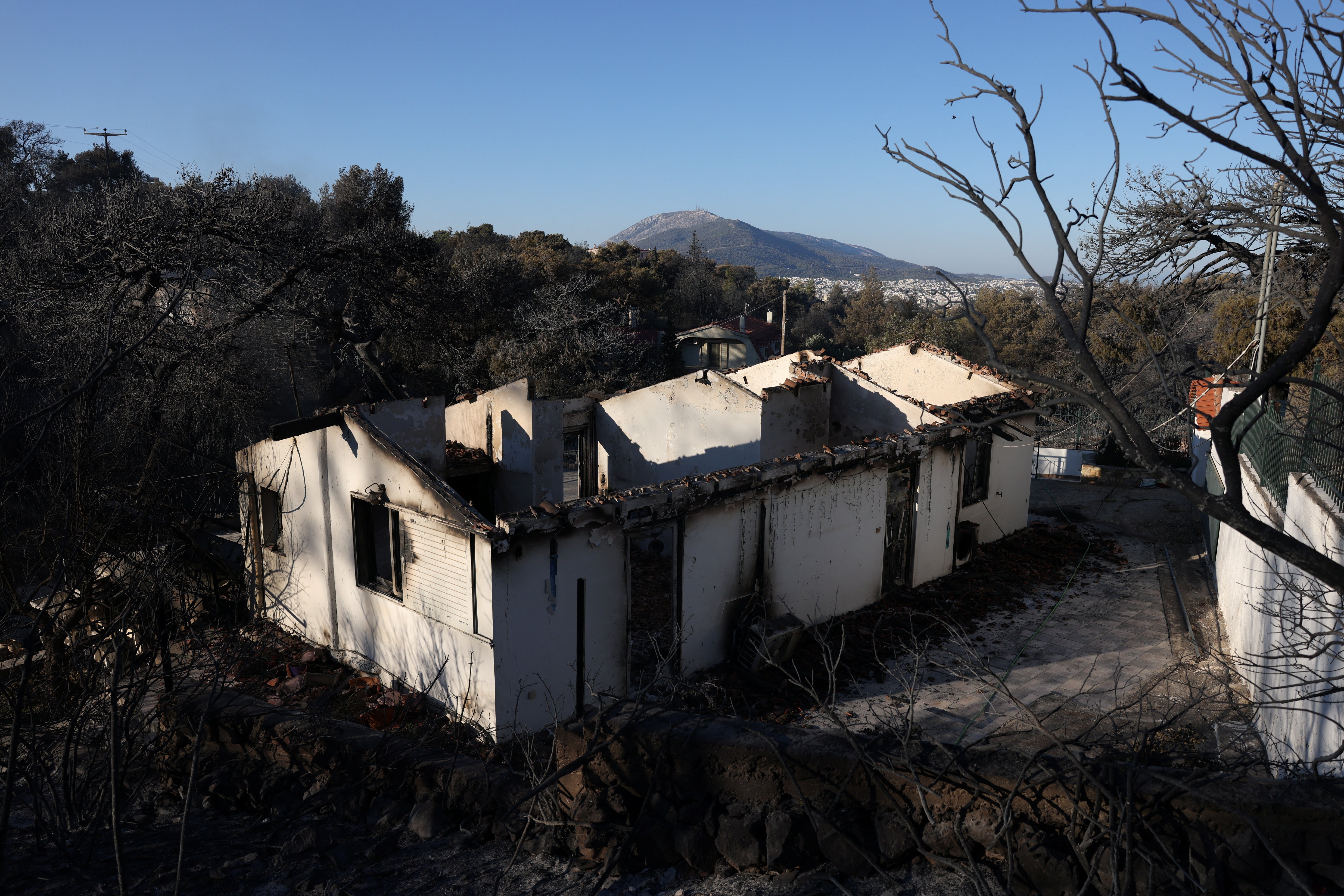 Burned houses are seen following a wildfire in the Penteli area near Athens, Greece