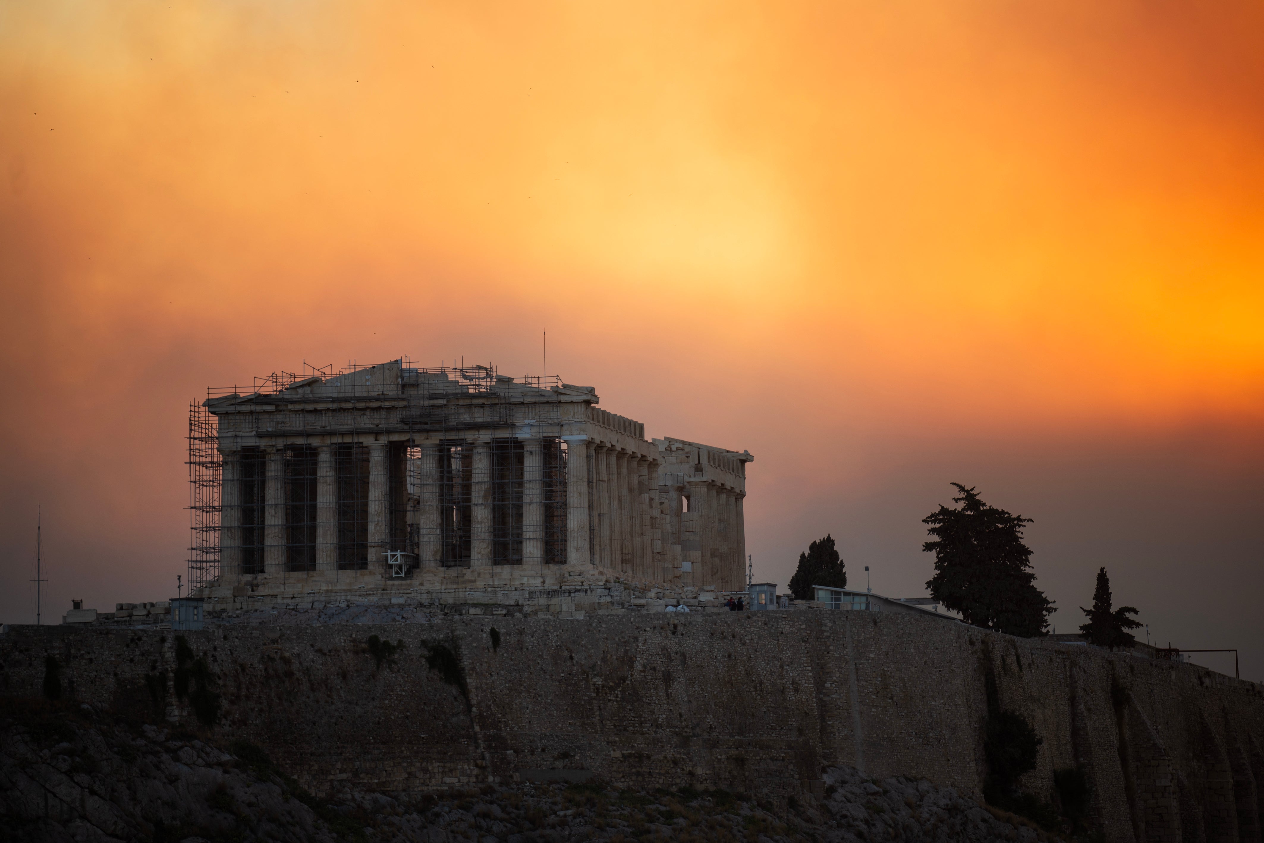 This photograph shows the Parthenon temple atop the Acropolis hill in a smoke cloud from a wildfire