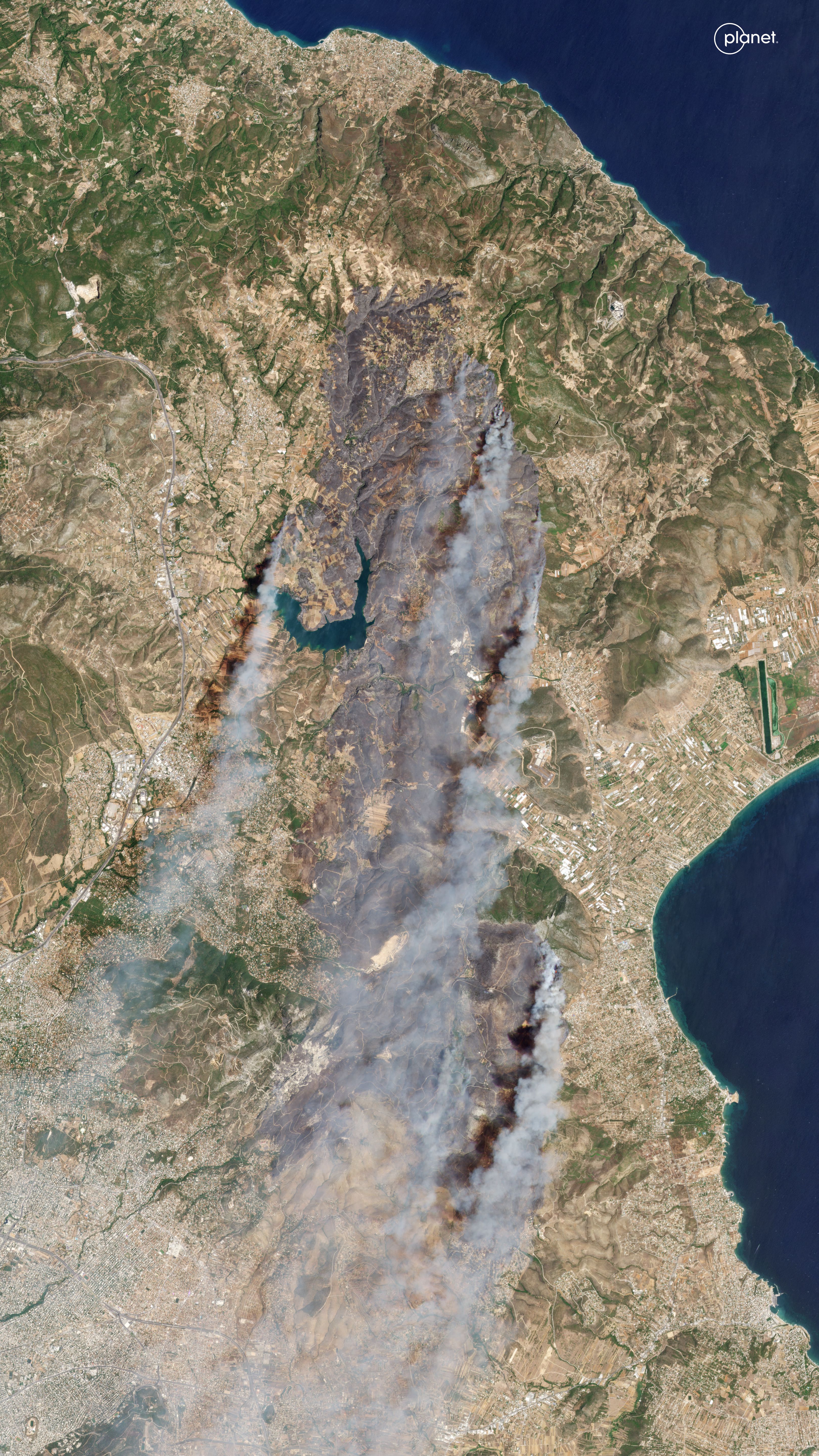 This Planet Labs handout satellite picture shows East Attica, Greece, during a wildfire