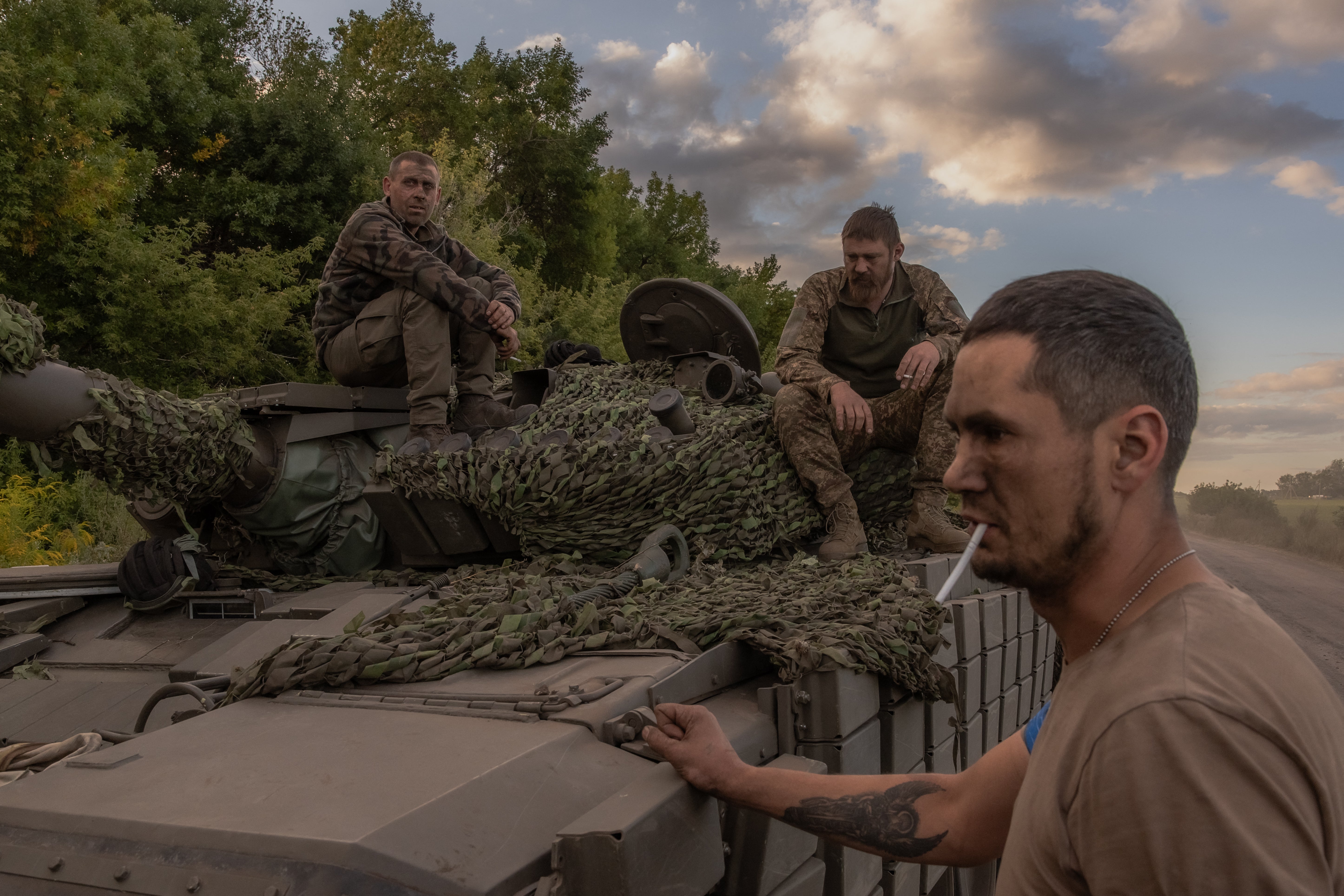 Ukrainian tank crew take a break while operating a Soviet-made T-72 tank in the Sumy region, near the border with Russia