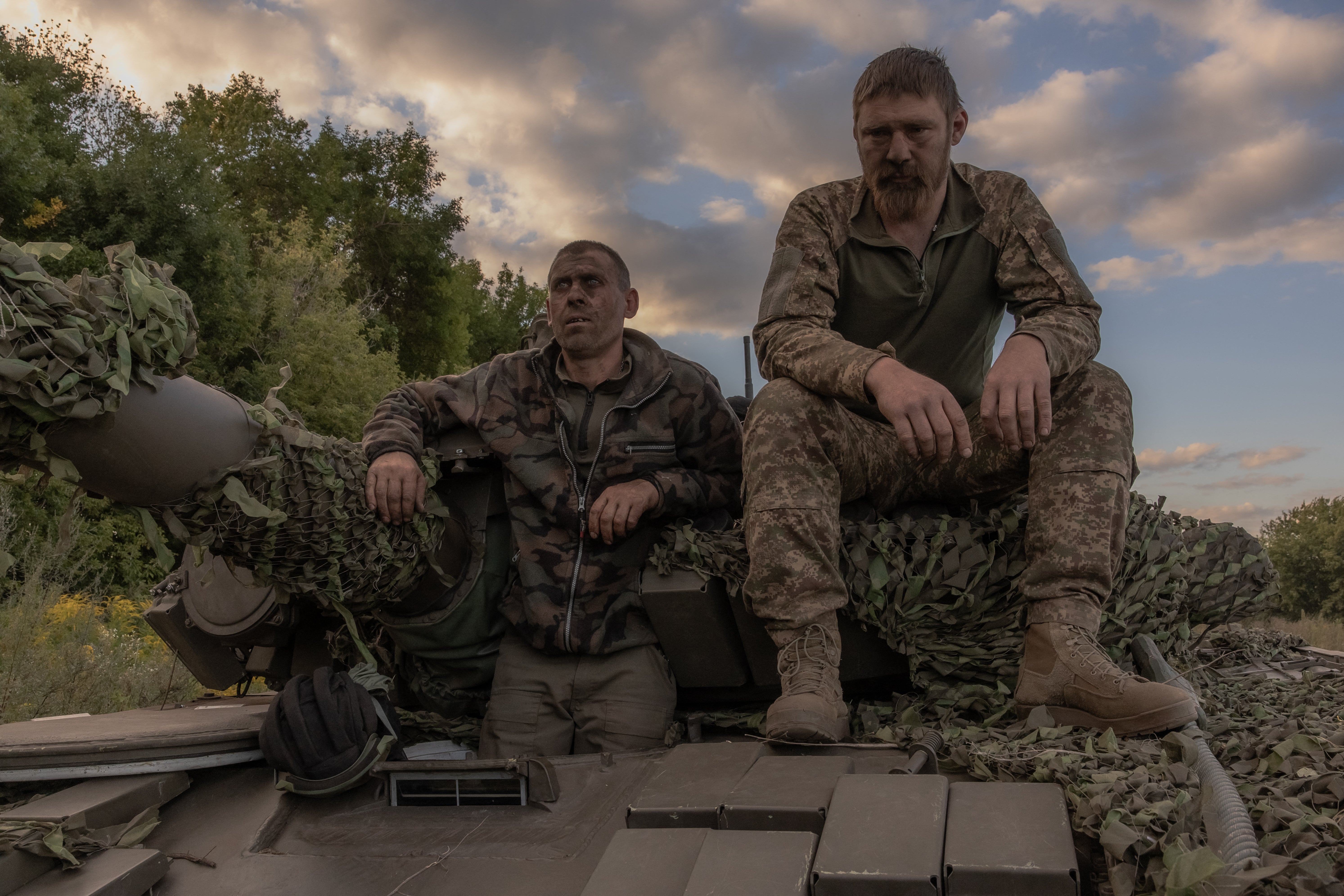 A Ukrainian tank crew take a break while operating a Soviet-made T-72 tank in the Sumy region, near the border with Russia