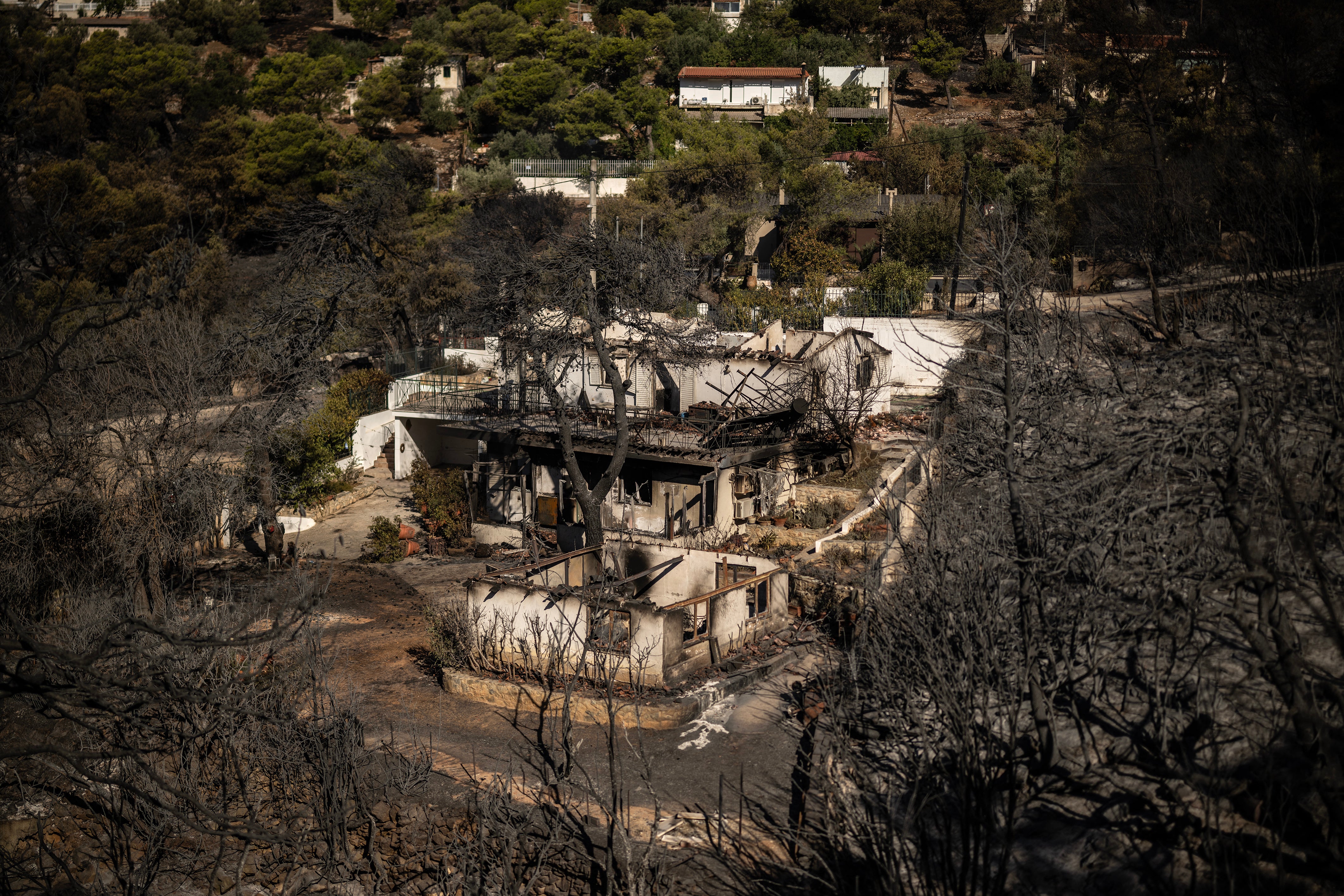 View of a burnt houses following a wildfire that hit the north-eastern suburbs of Athens, near Penteli, suburb of Athens