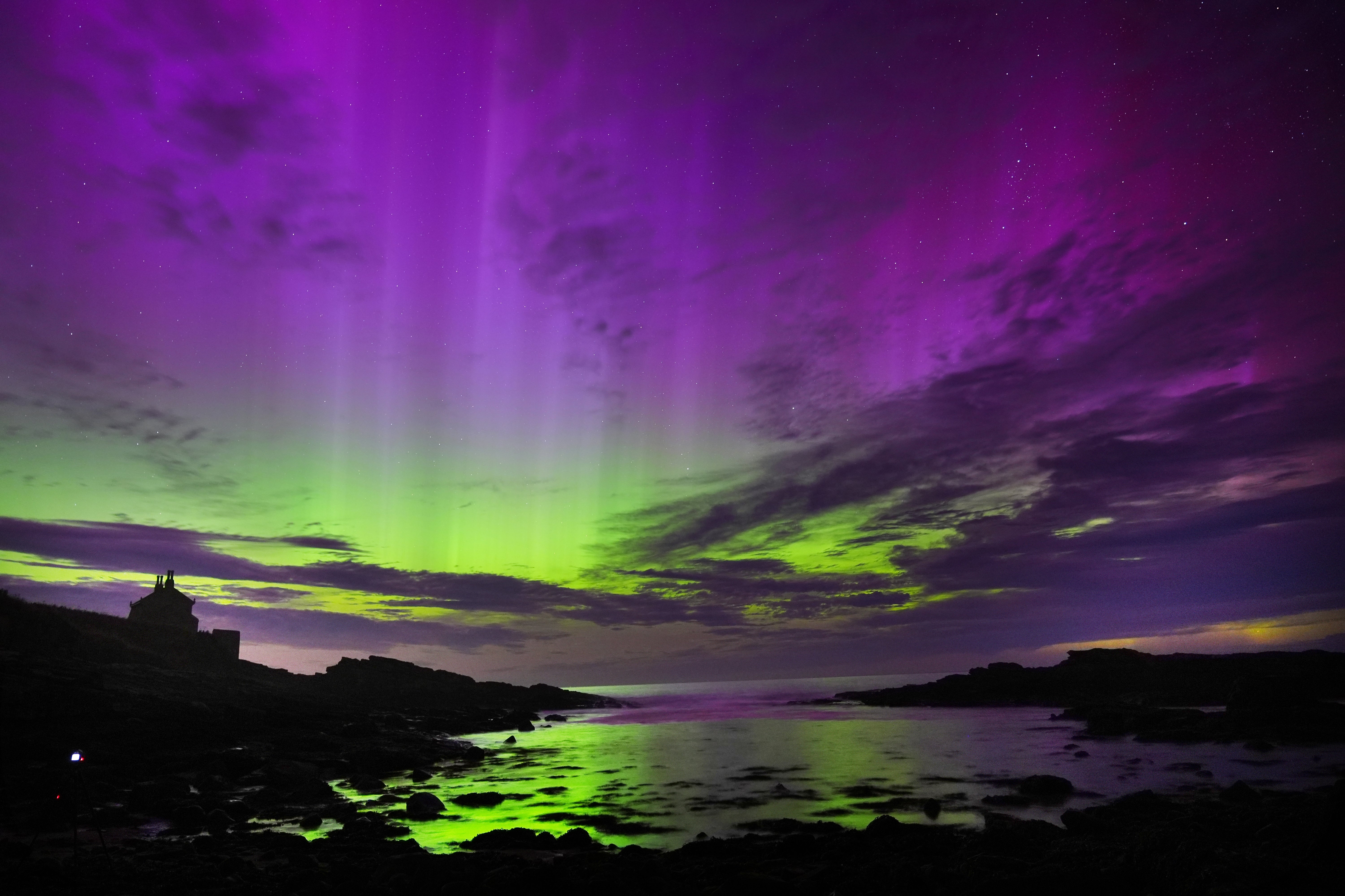 Aurora borealis fills the sky over the Bathing House in Howick, Northumberland