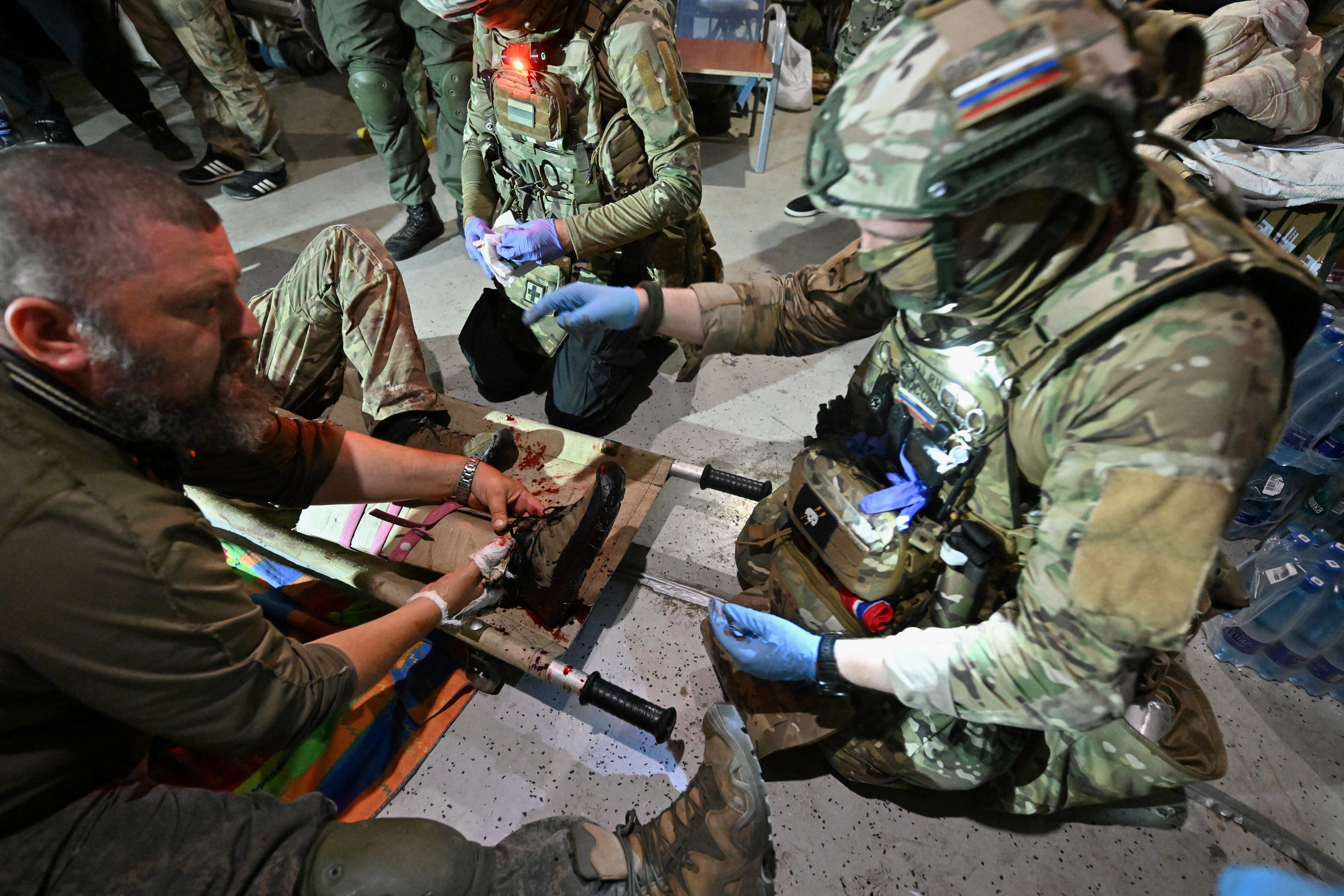 Russian medics help attend to a patient in a field hospital at an undisclosed location in the Kursk region