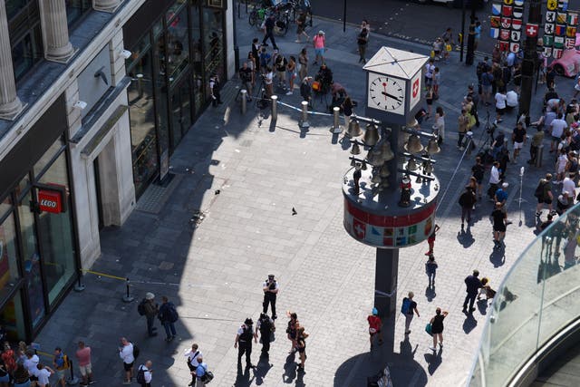 Police officers at the scene in Leicester Square, London (James Manning/PA)