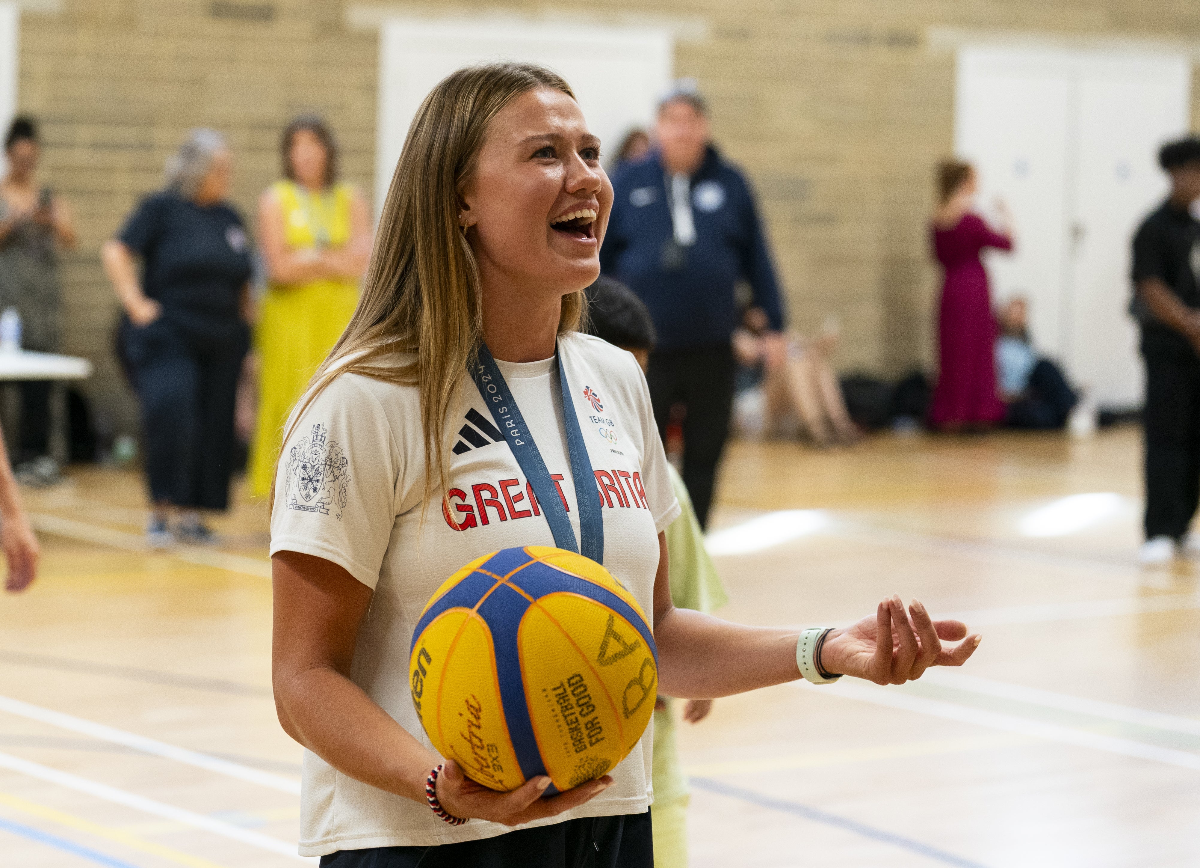 Rower Lola Anderson plays basketball with children during the photocall at North Paddington Youth Club (Jordan Pettitt/PA)