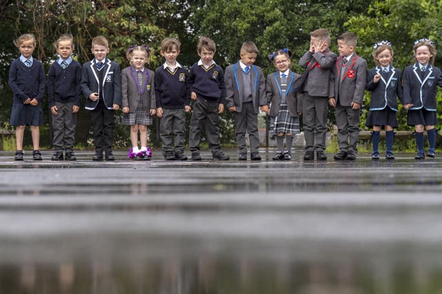 The twins all start school later this week (Jane Barlow/PA)