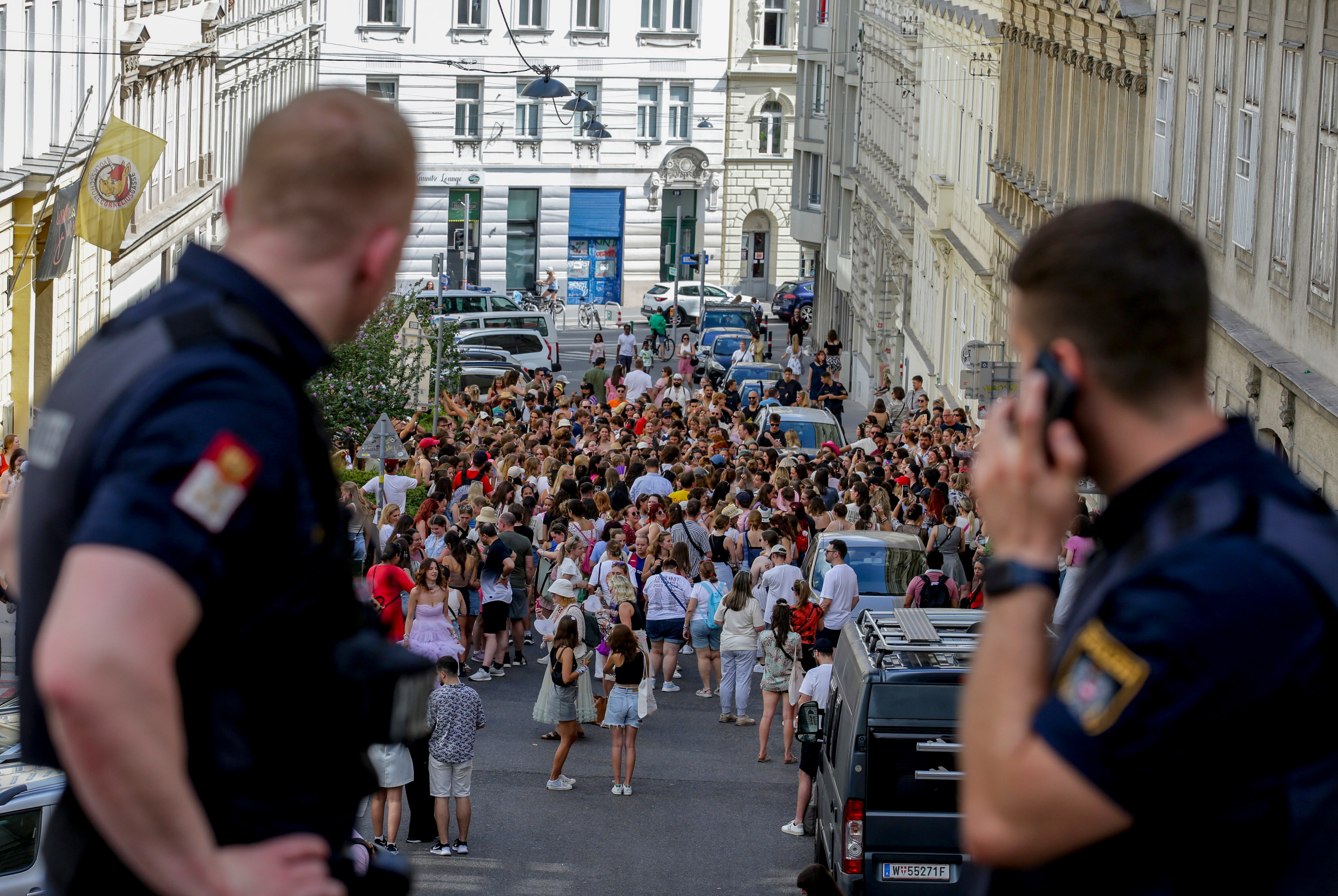 Austrian police officers observe Taylor Swift fans gathering in the city center in Vienna on August 8