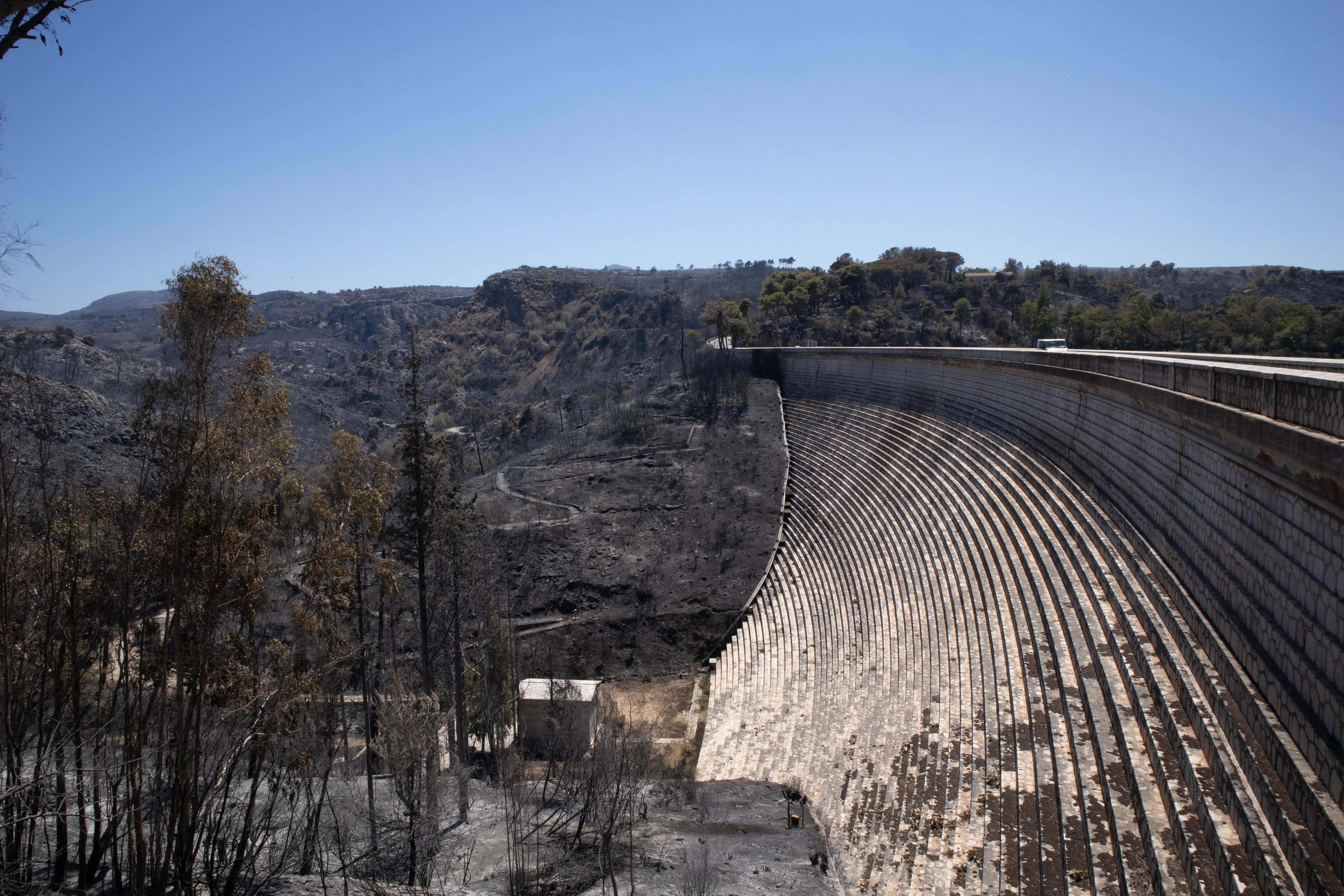 Land destroyed by fire on one side of the dam at Lake Marathon