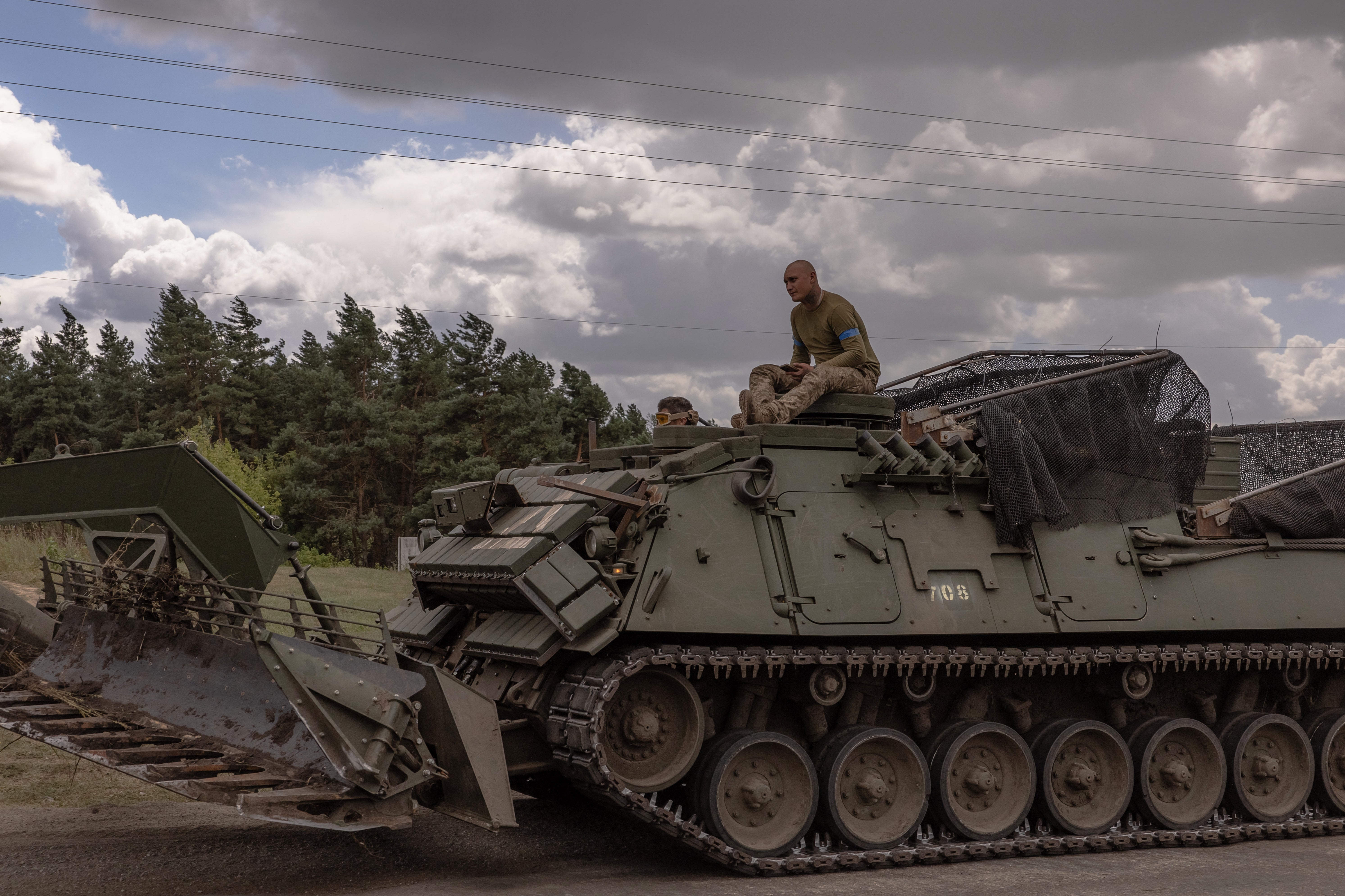 Ukrainian servicemen operate an armoured military vehicle in the Sumy region, near the border with Russia