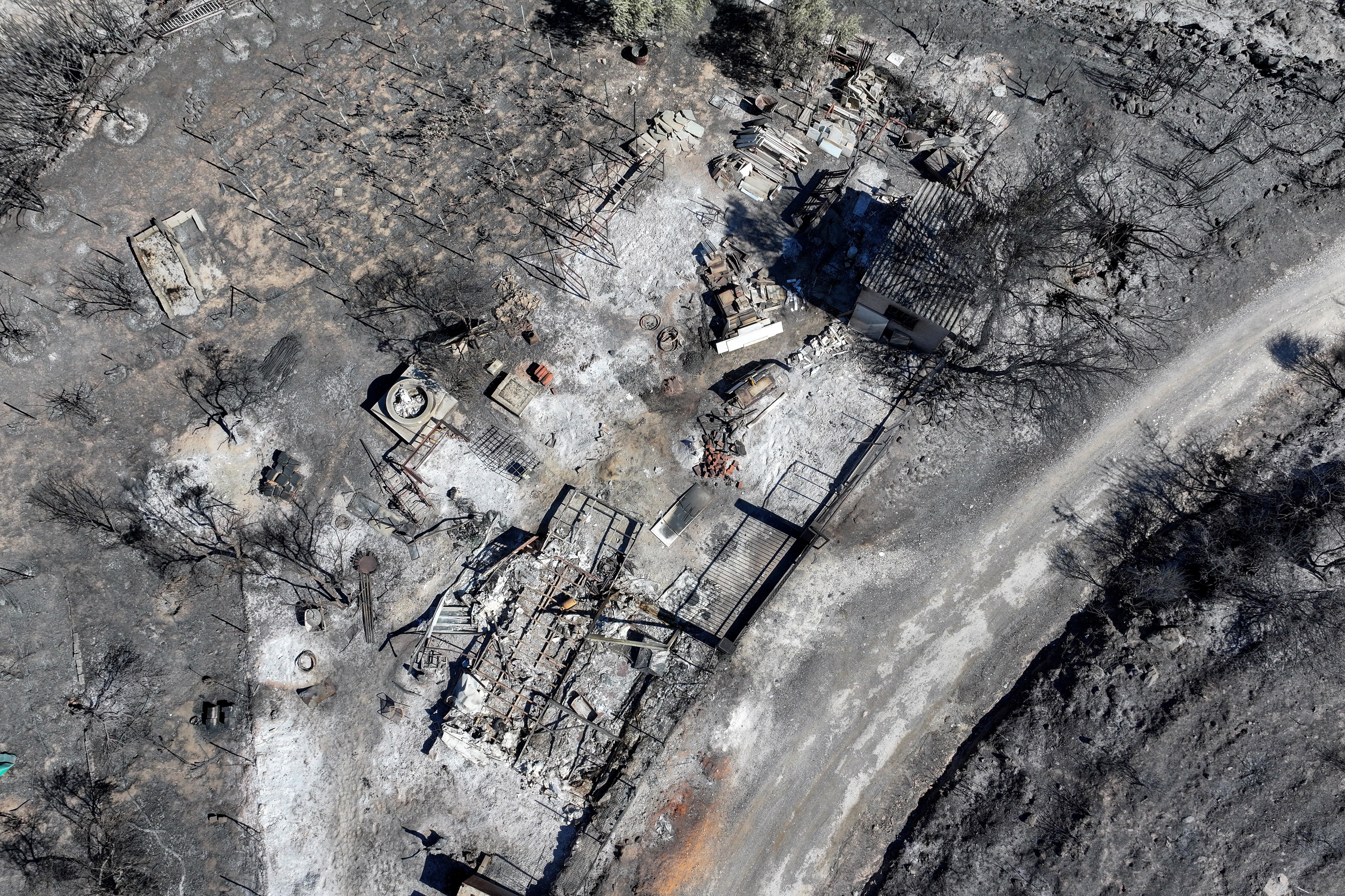 Una foto scattata da un drone mostra un’area carbonizzata dopo un incendio boschivo nel villaggio di Rabintosa, in Grecia.