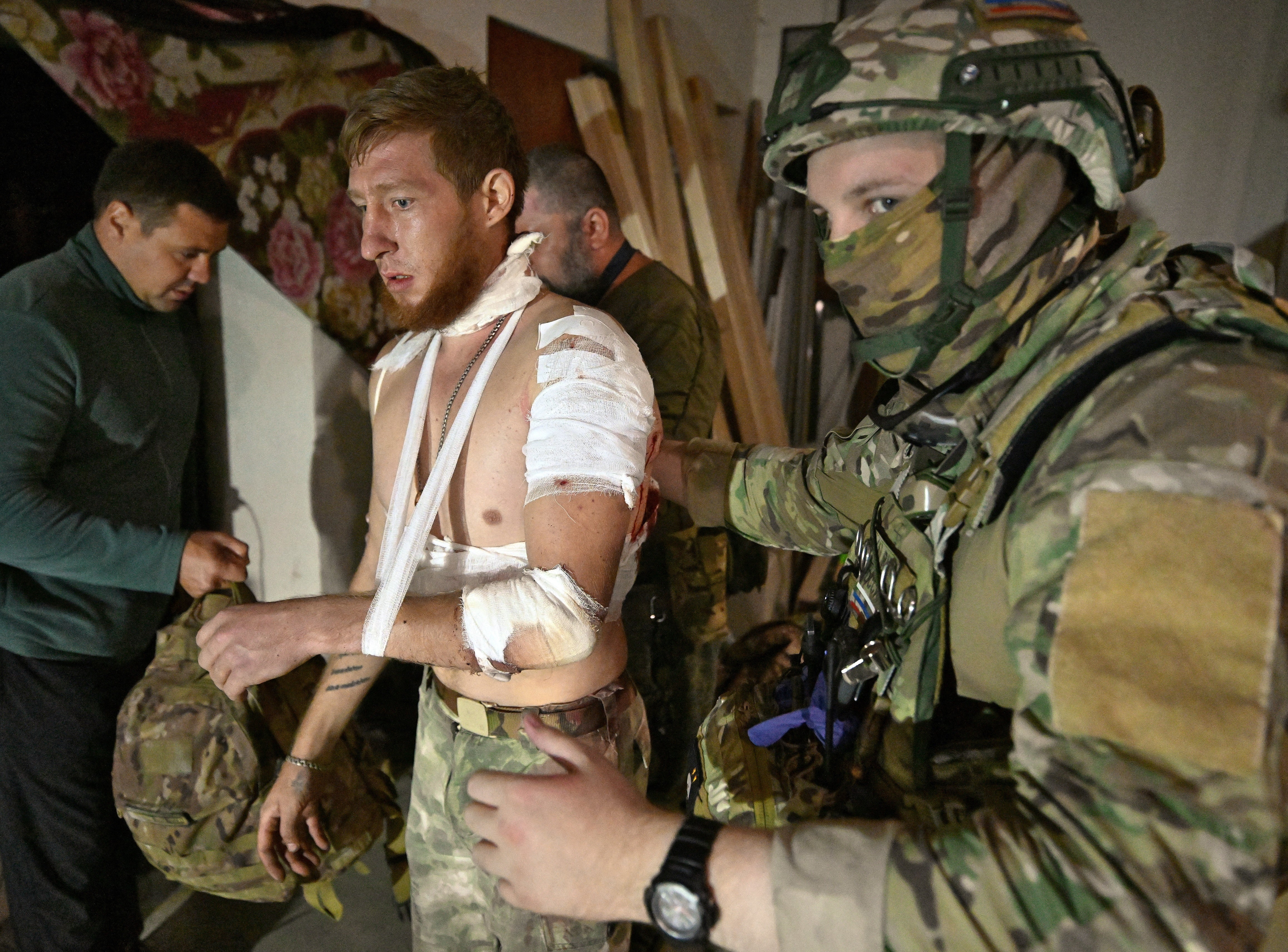 Medics help a resident in a field hospital at an undisclosed location in the Kursk region