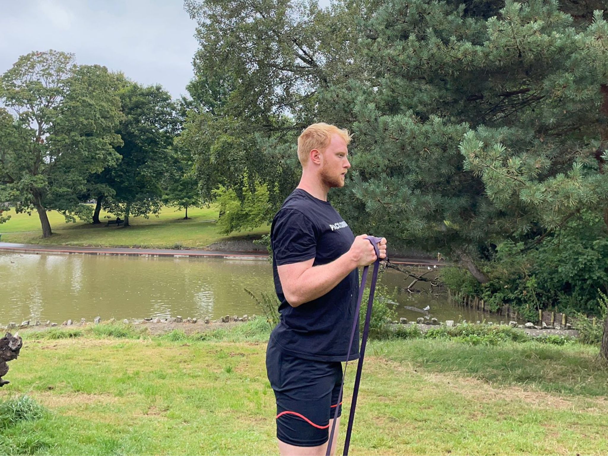 A banded biceps curl, performed by fitness writer Harry Bullmore