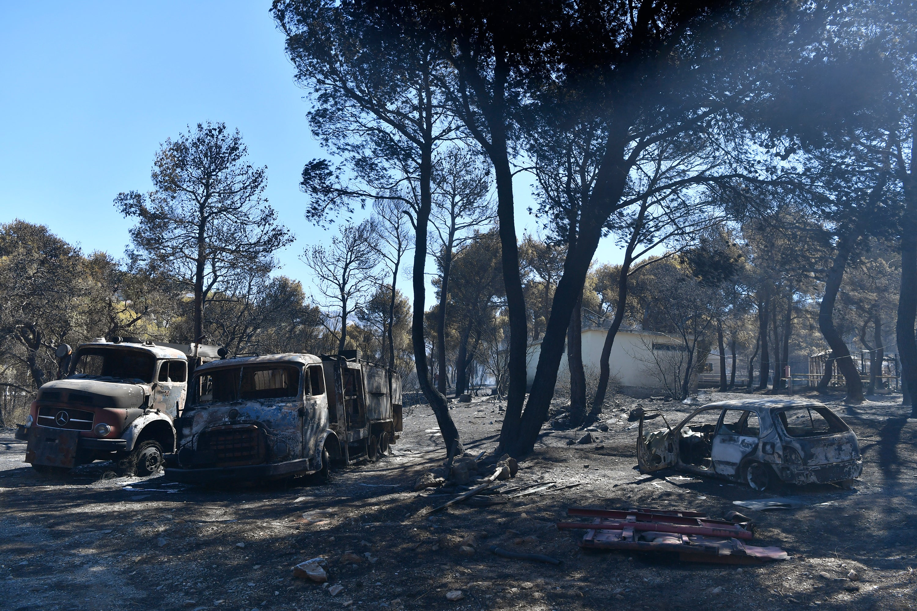 Burned vehicles are parked in Nea Penteli suburb of Athens, on Tuesday, Aug. 13, 2024