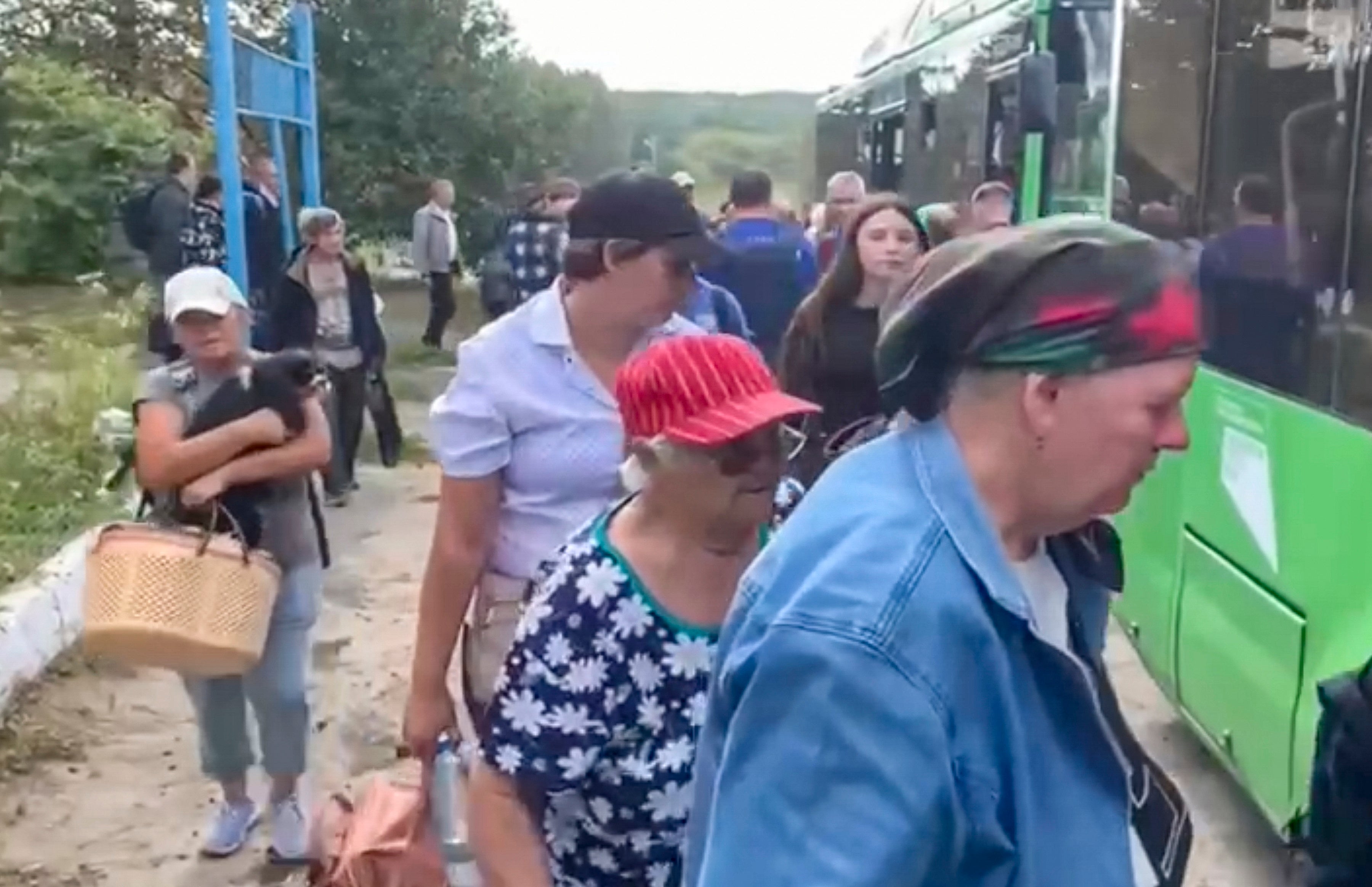 Russian civilians get on buses to be evacuated from their homes in border settlements in Kursk