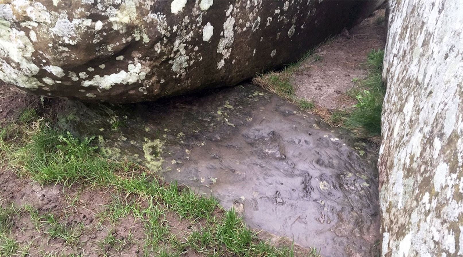 The now partly buried (sunken in the ground) altar stone