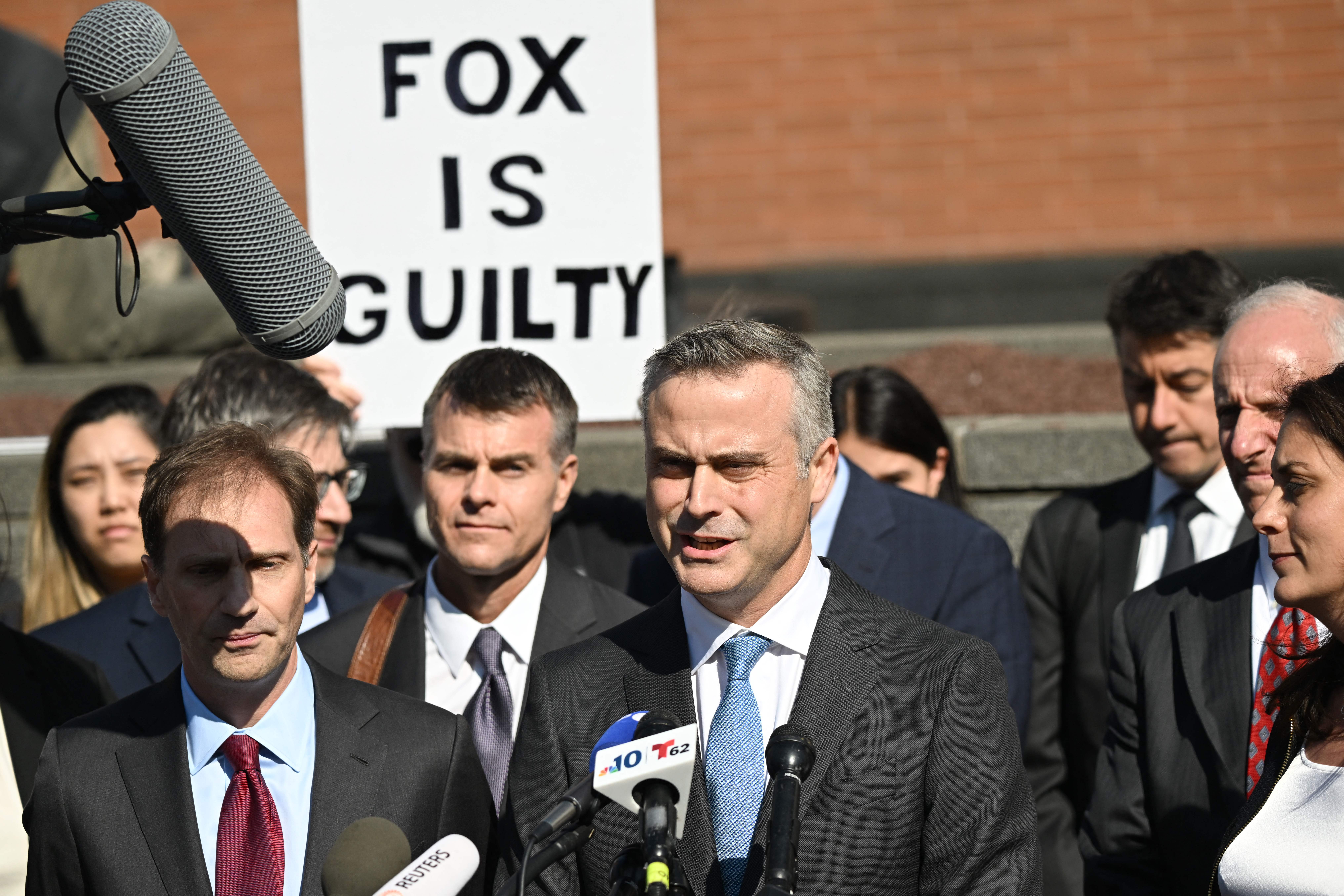 Dominion CEO John Poulos, and his legal team, speak outside a Delaware courthouse in April 2023 after reaching a settlement in a defamation case against Fox News for more than $787m.