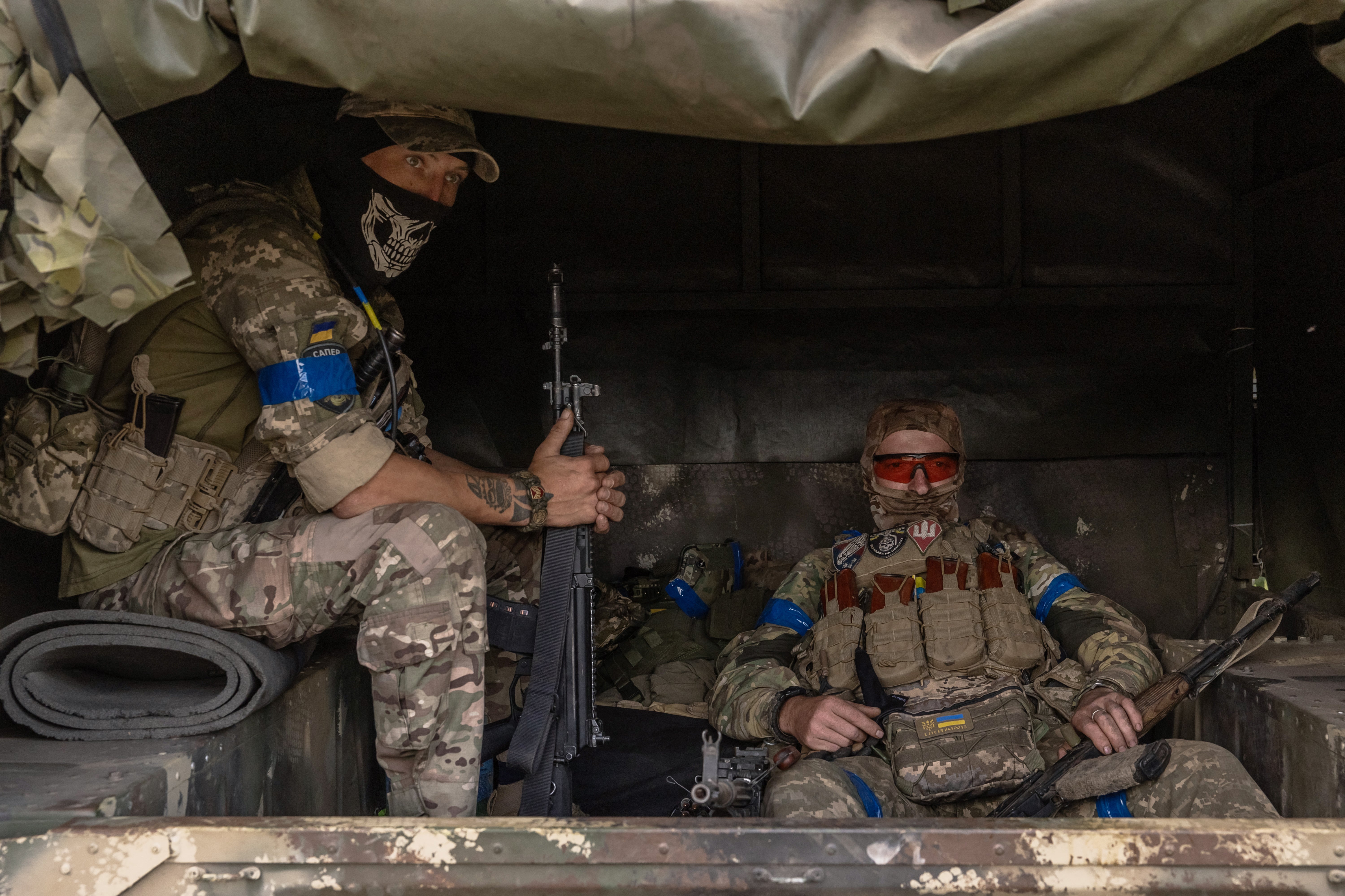 Ukrainian servicemen wait in a military vehicle to head for a combat mission, in the Sumy region, near the border with Russia