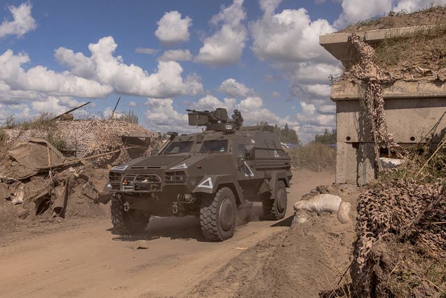 <p>A Ukrainian military vehicle drives past a destroyed border crossing point with Russia, in the Sumy region</p>