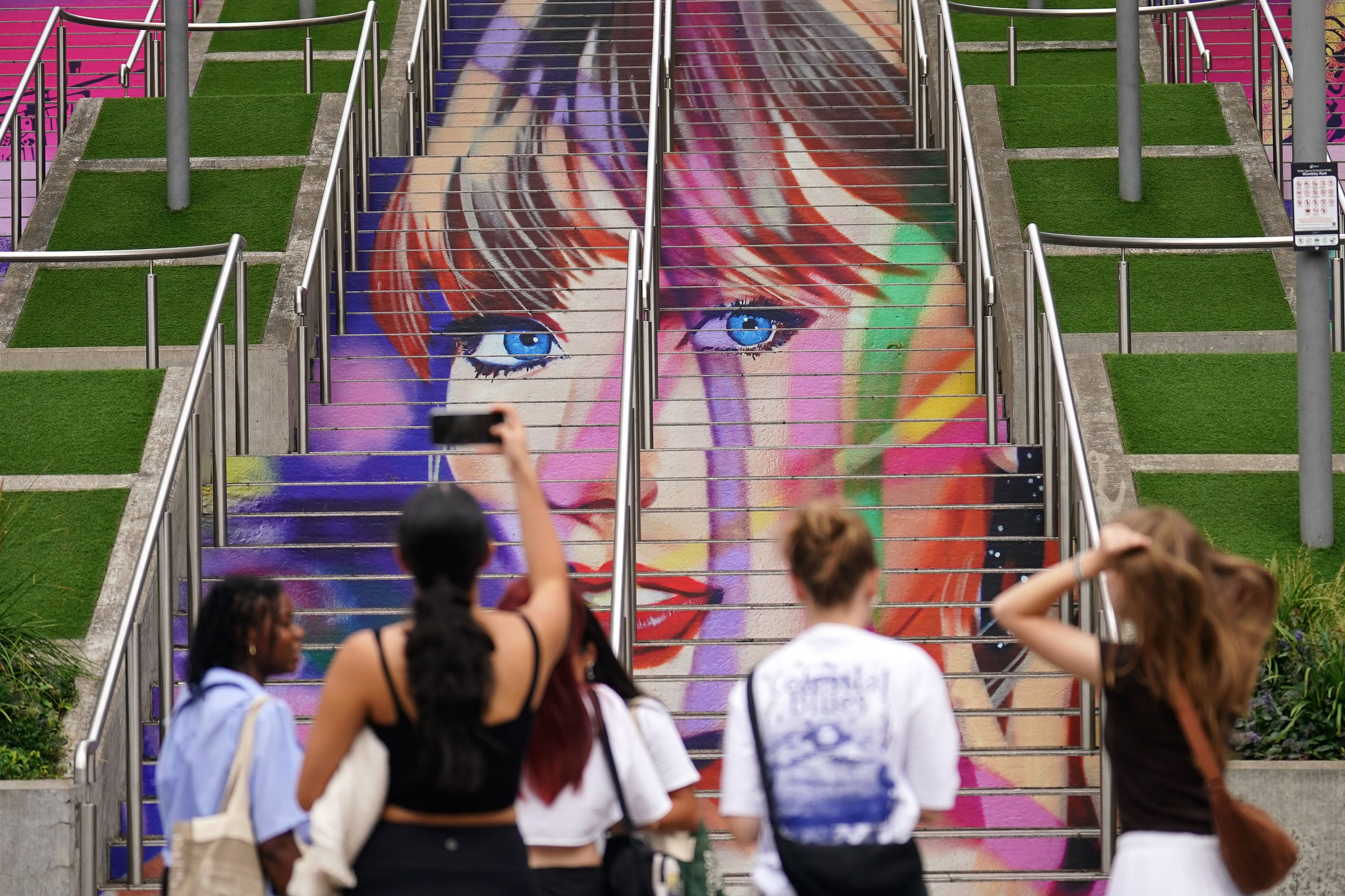 Swifties take photographs of the Swiftie Steps (Yui Mok/PA)